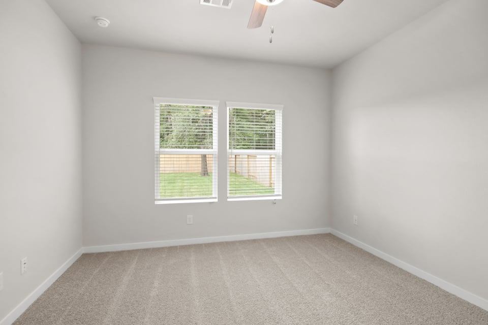 A room with a window and a carpet.