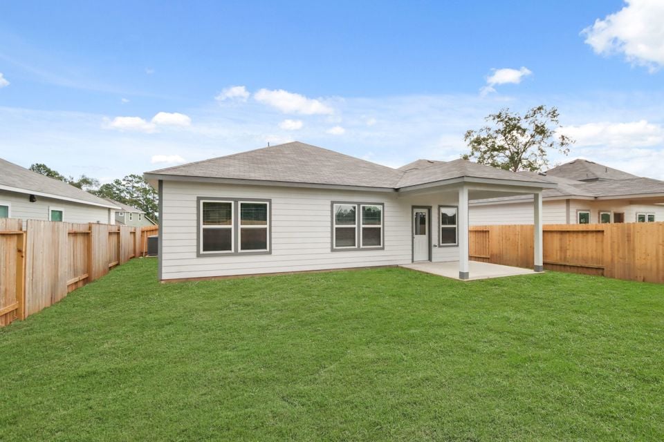 A house with a fence and grass.