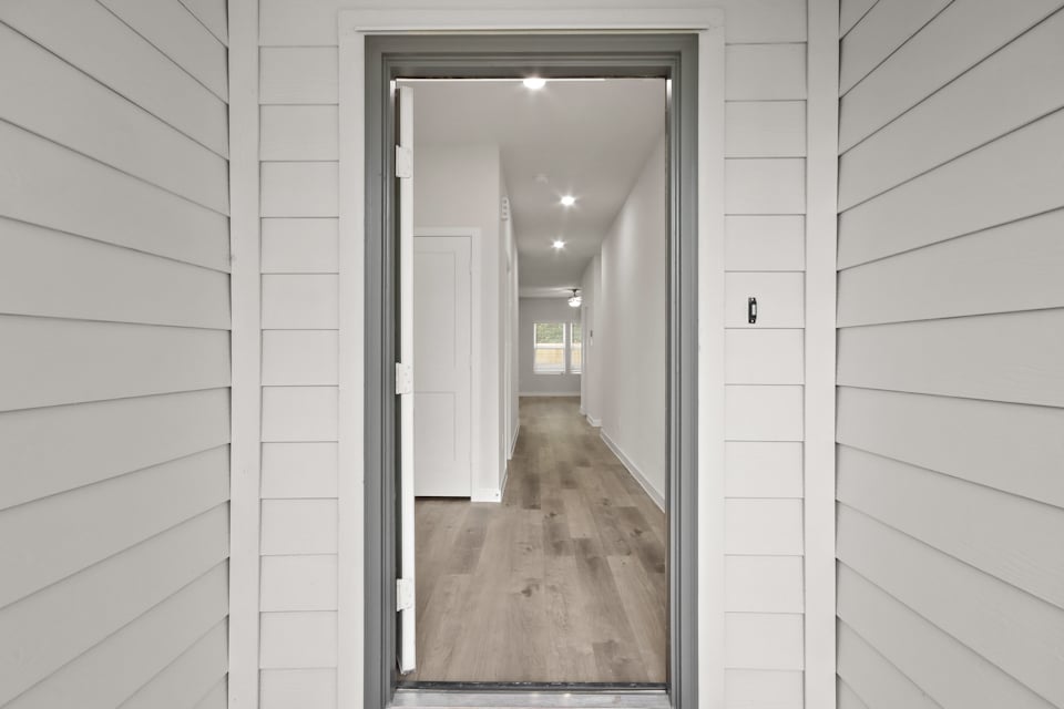 A hallway with white walls.