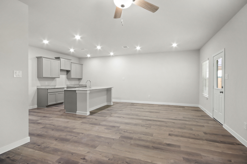 A kitchen with white cabinets.