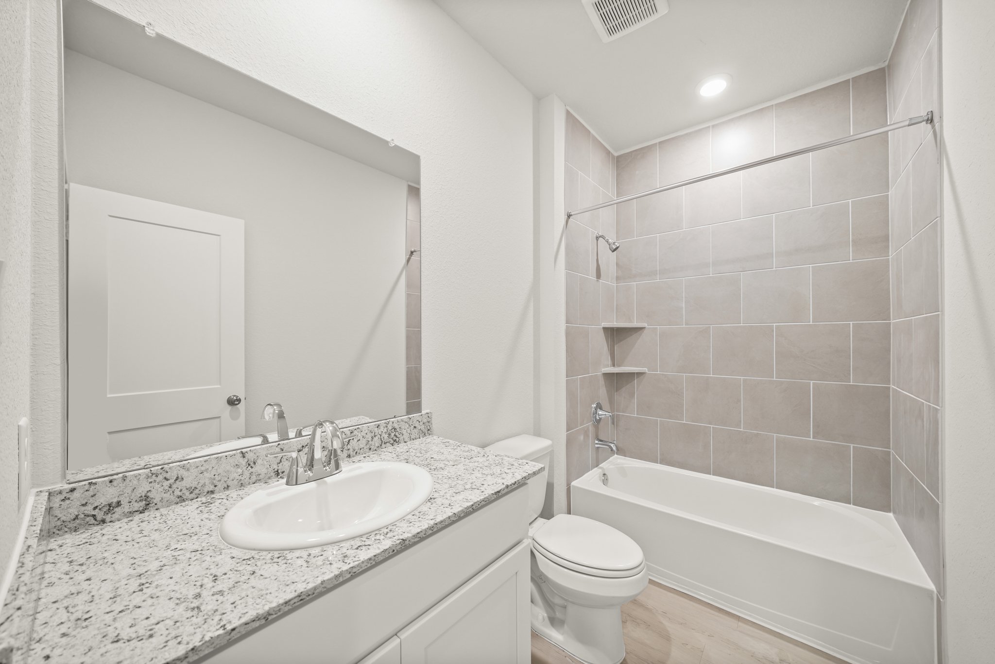 A bathroom with a marble countertop.