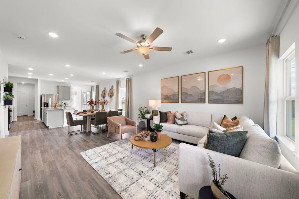 A living room with a chandelier and a couch.