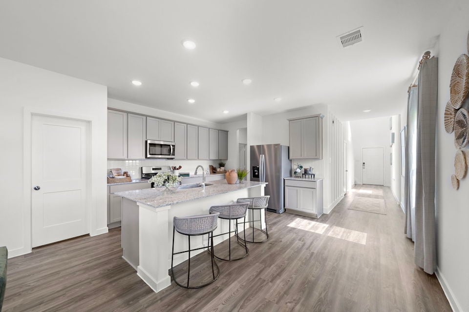 A kitchen with white cabinets.