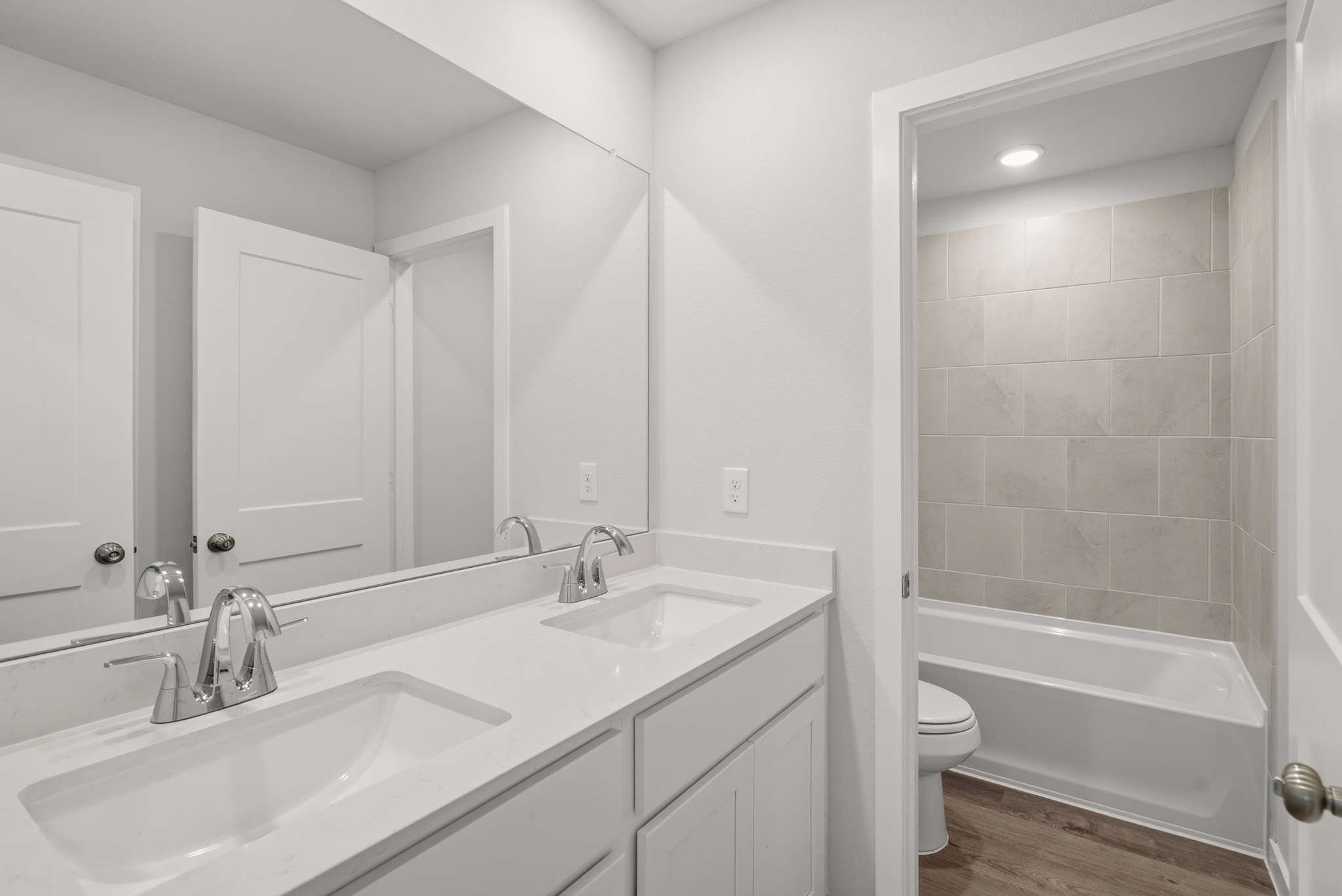A bathroom with a tub sink and toilet.