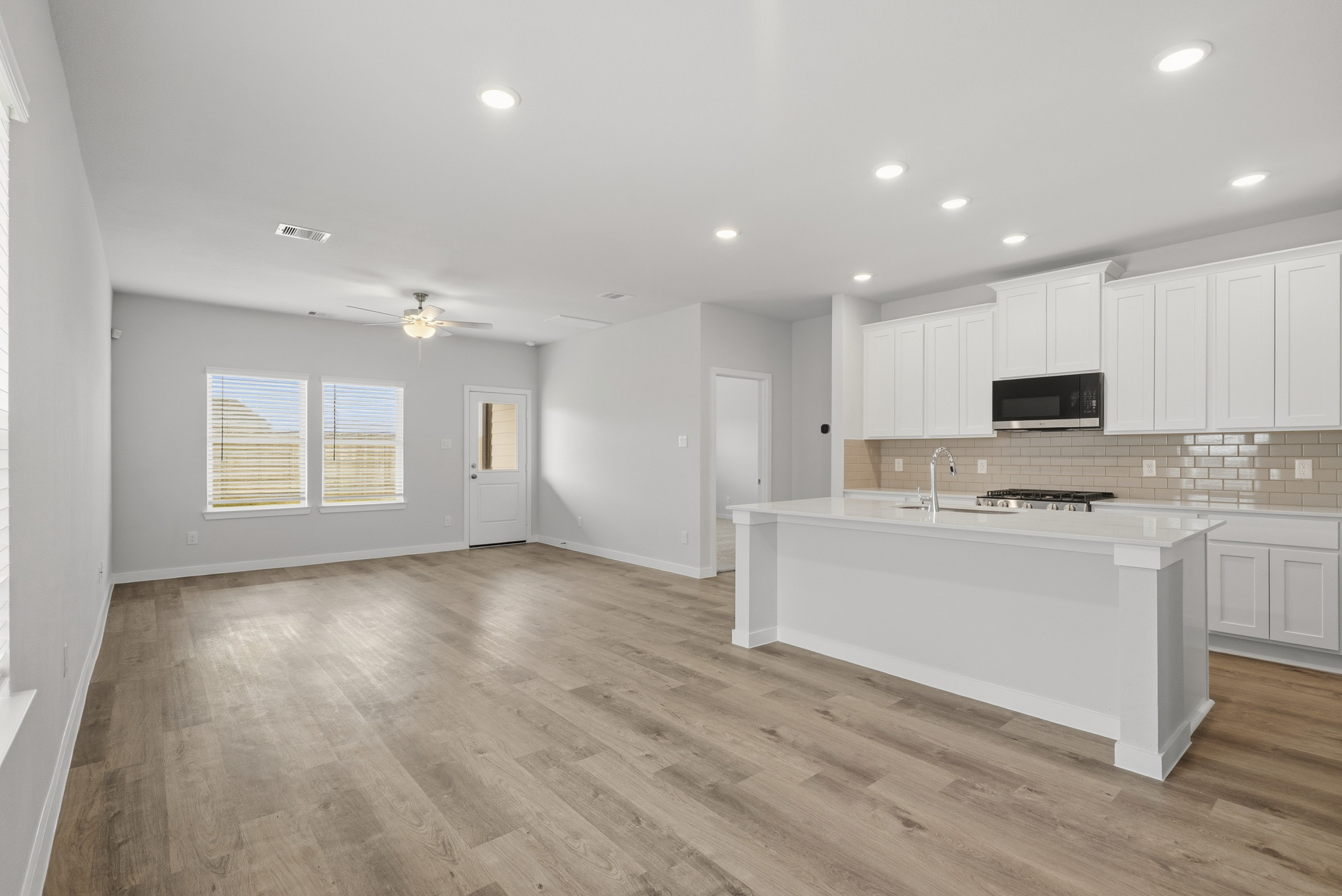 A large kitchen with white cabinets.