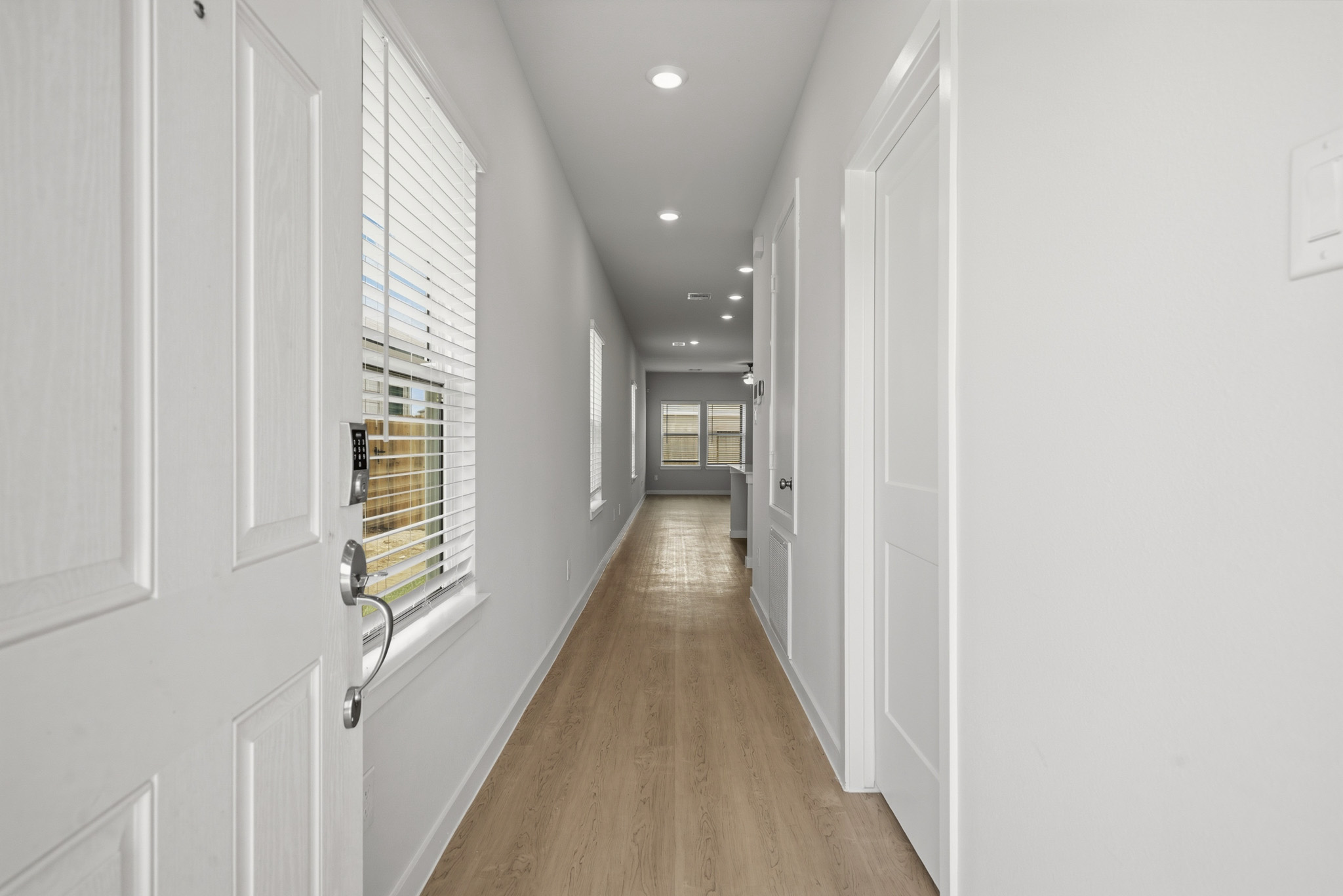 A hallway with white doors.