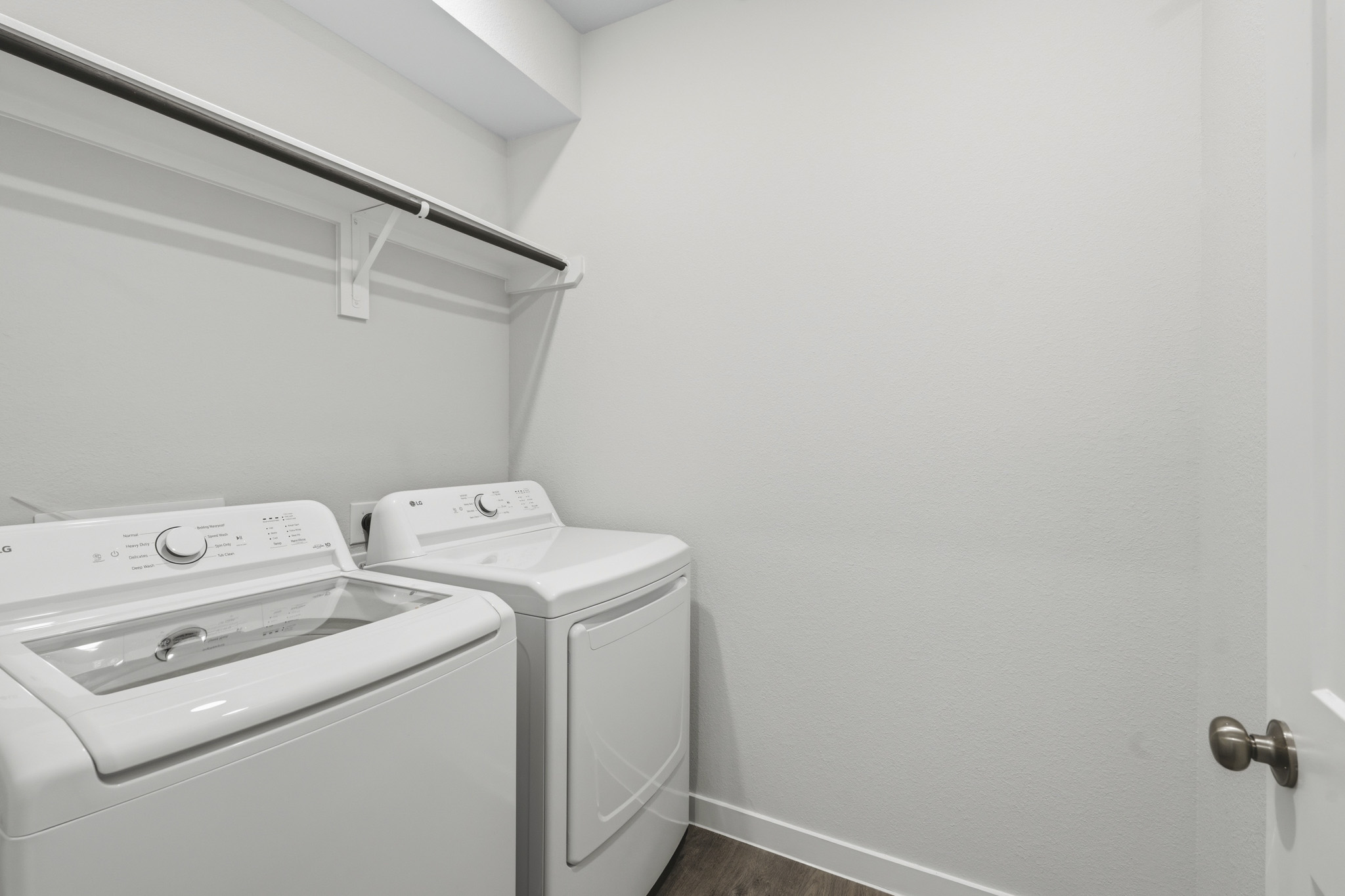 A washing machine and dryer in a room.