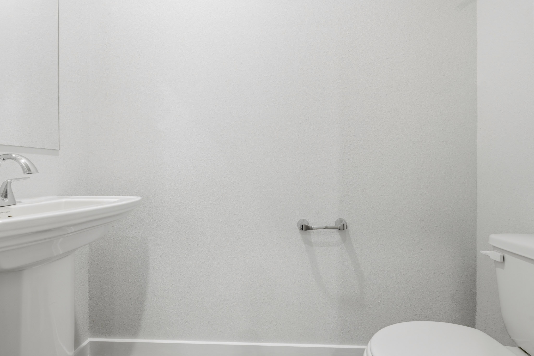 A bathroom with a sink and toilet.