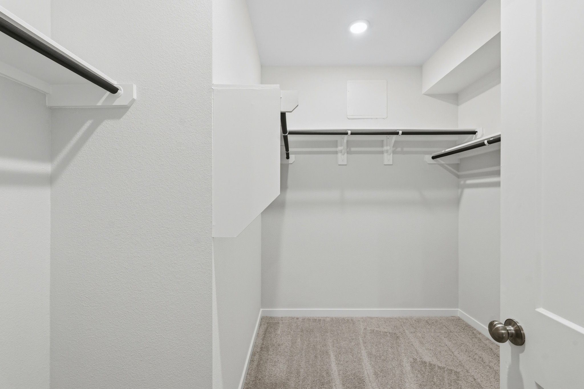 A white bathroom with a shower unit.