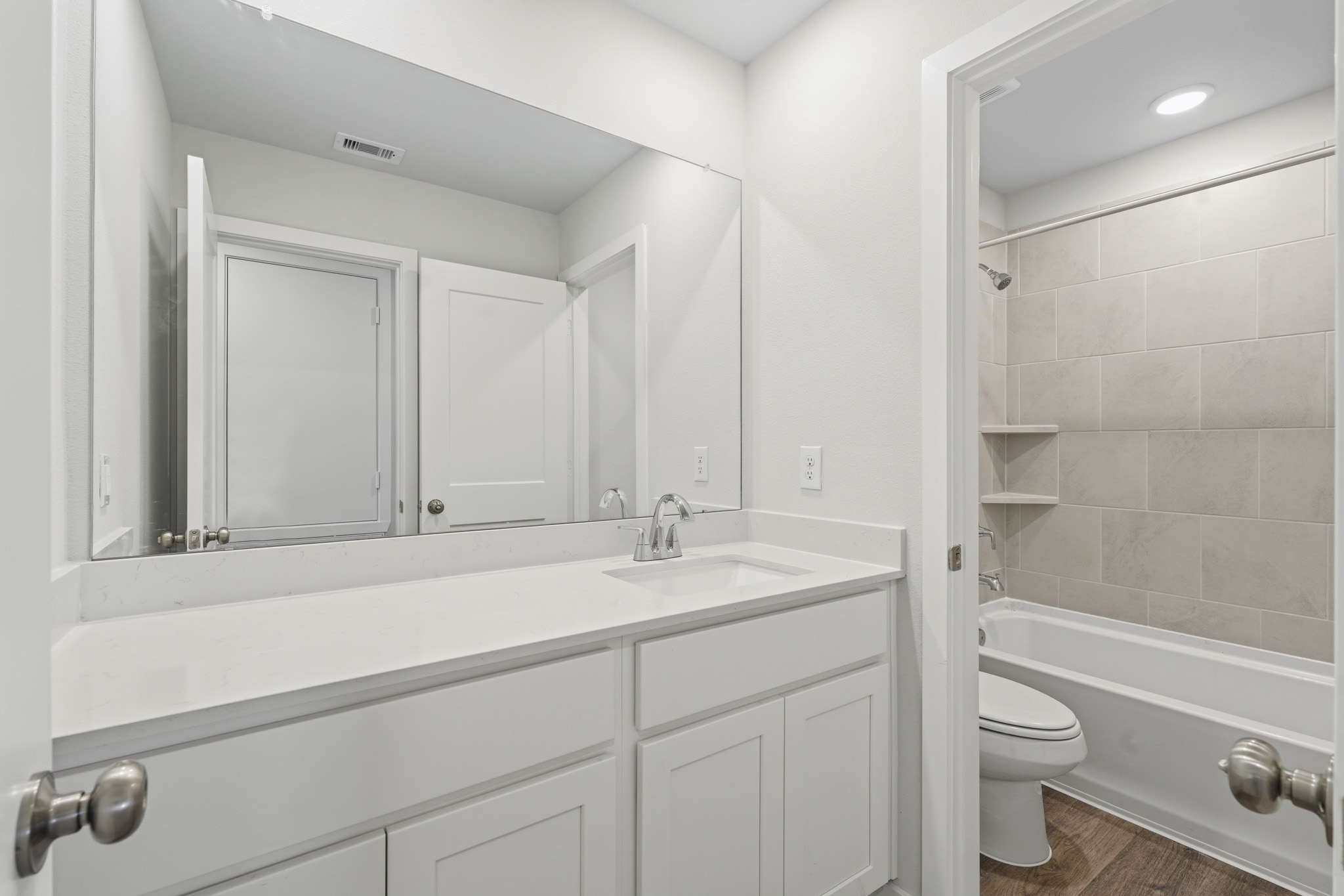 A bathroom with a toilet and sink.