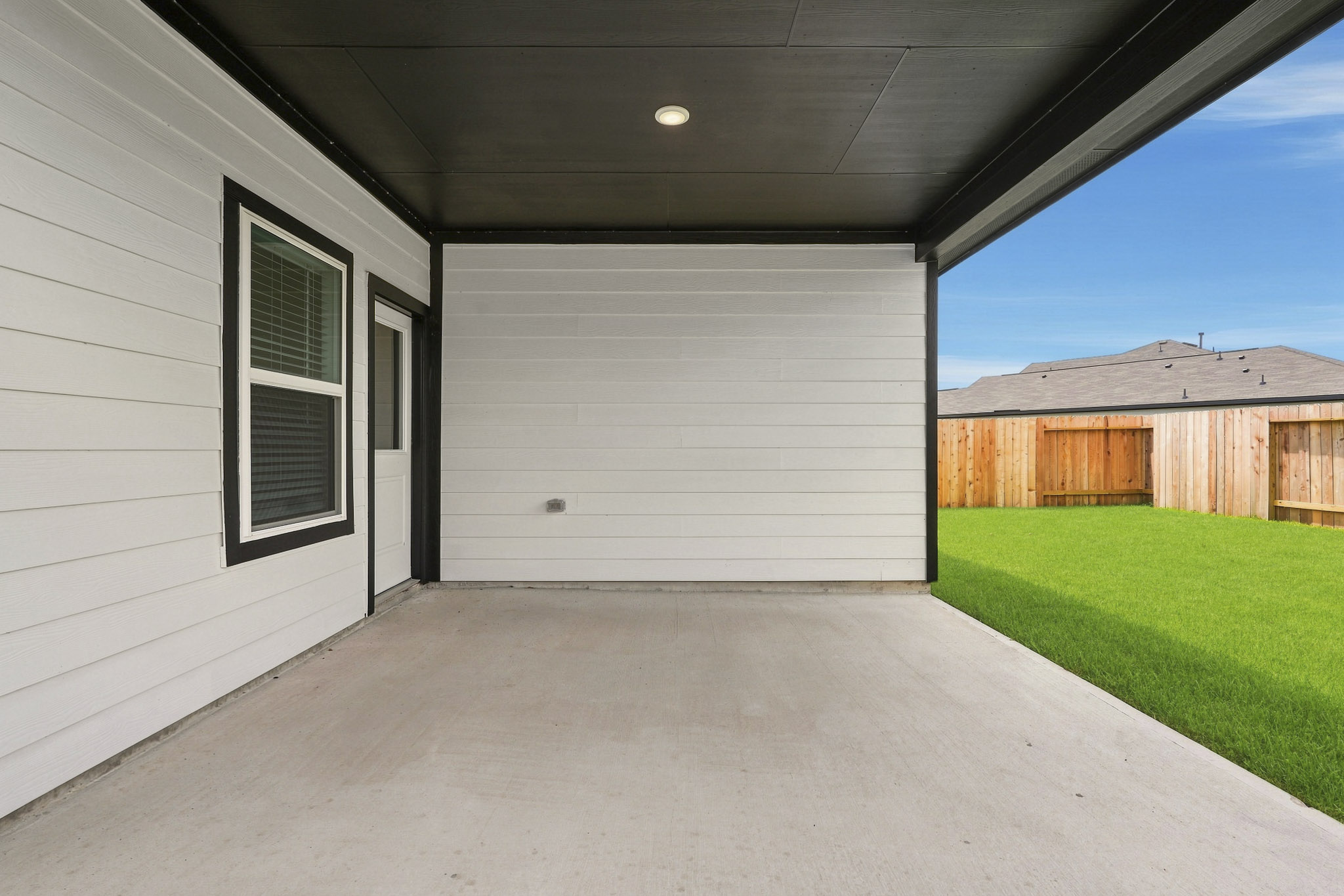 A garage with a grass lawn.