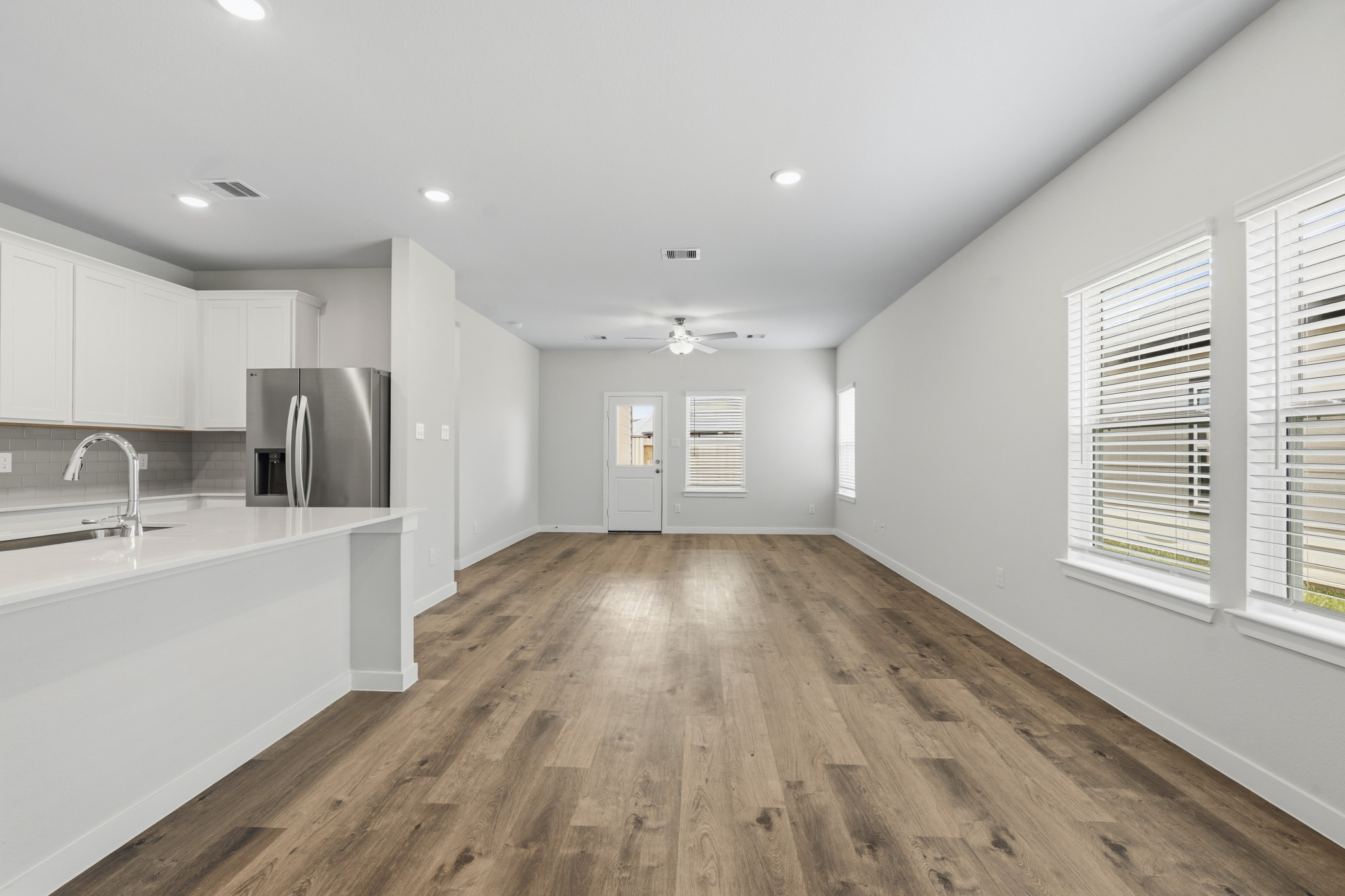 A kitchen with white cabinets.