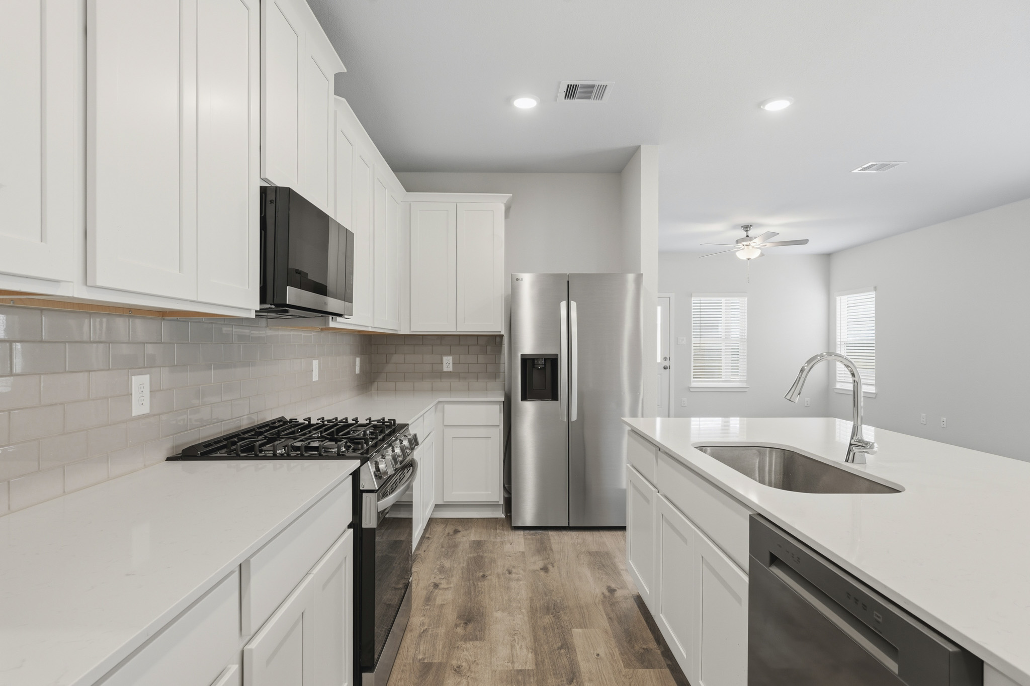 A kitchen with white cabinets.