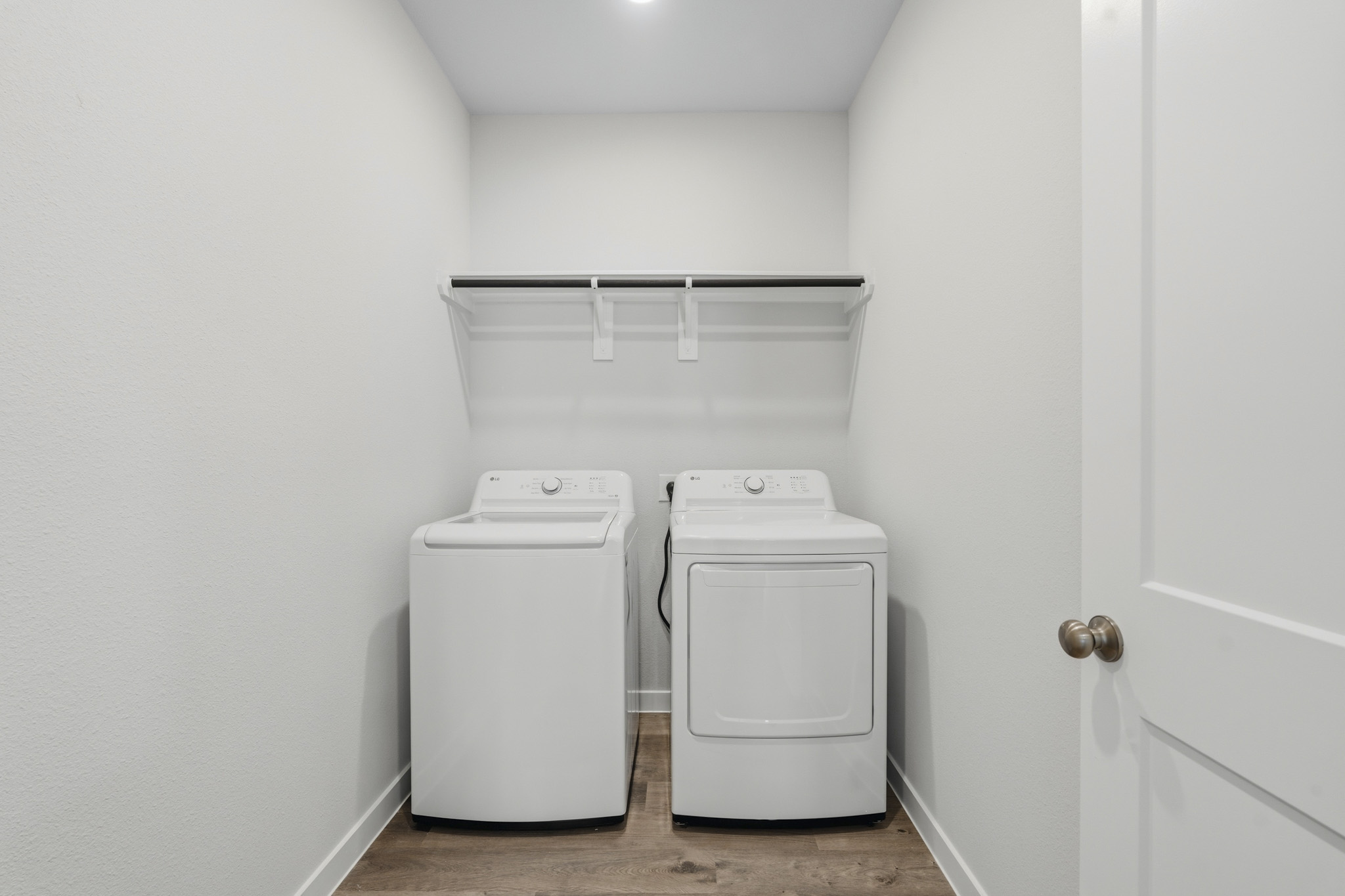 A washing machine and dryer in a room.