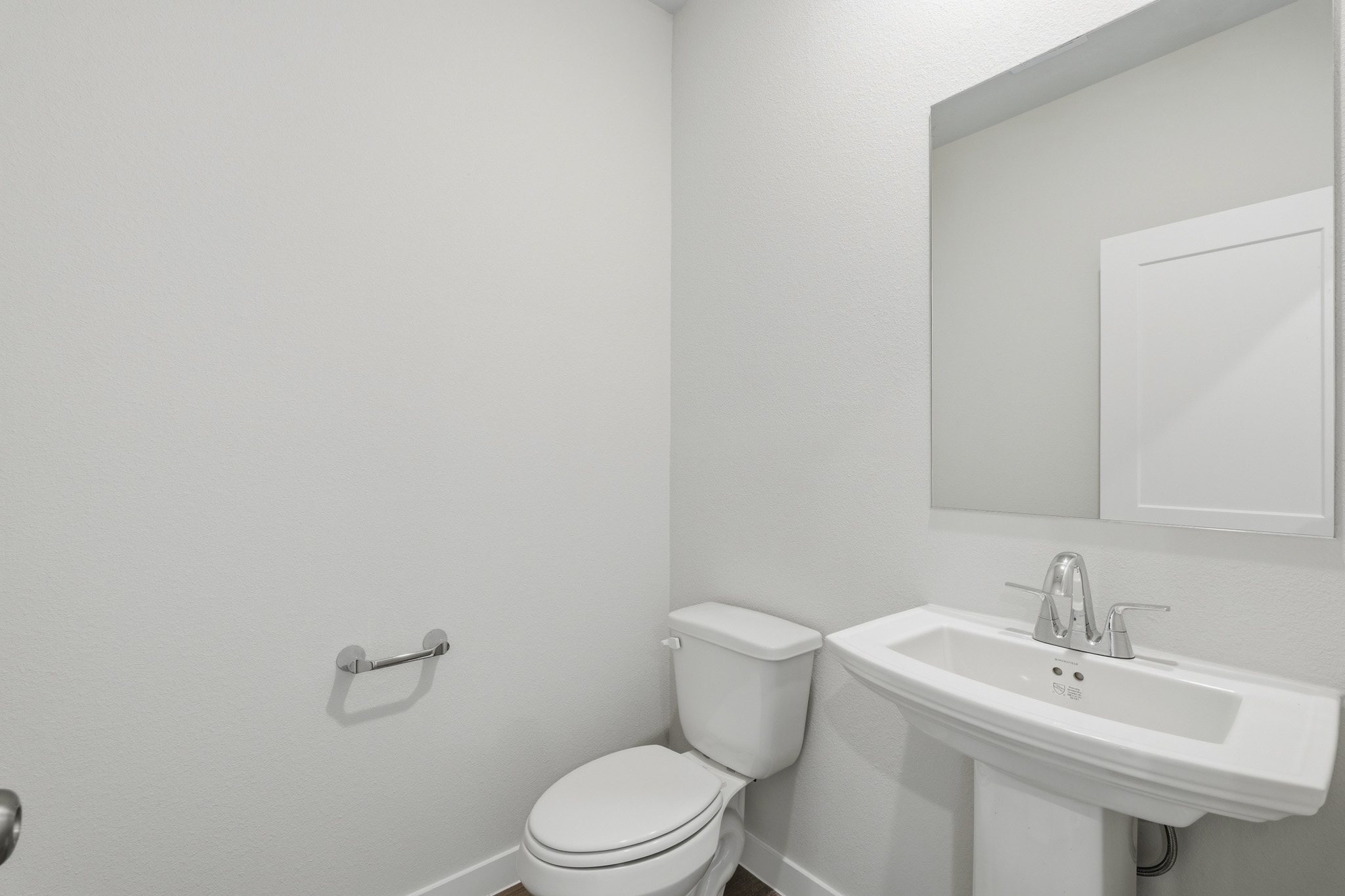 A bathroom with a toilet and sink.