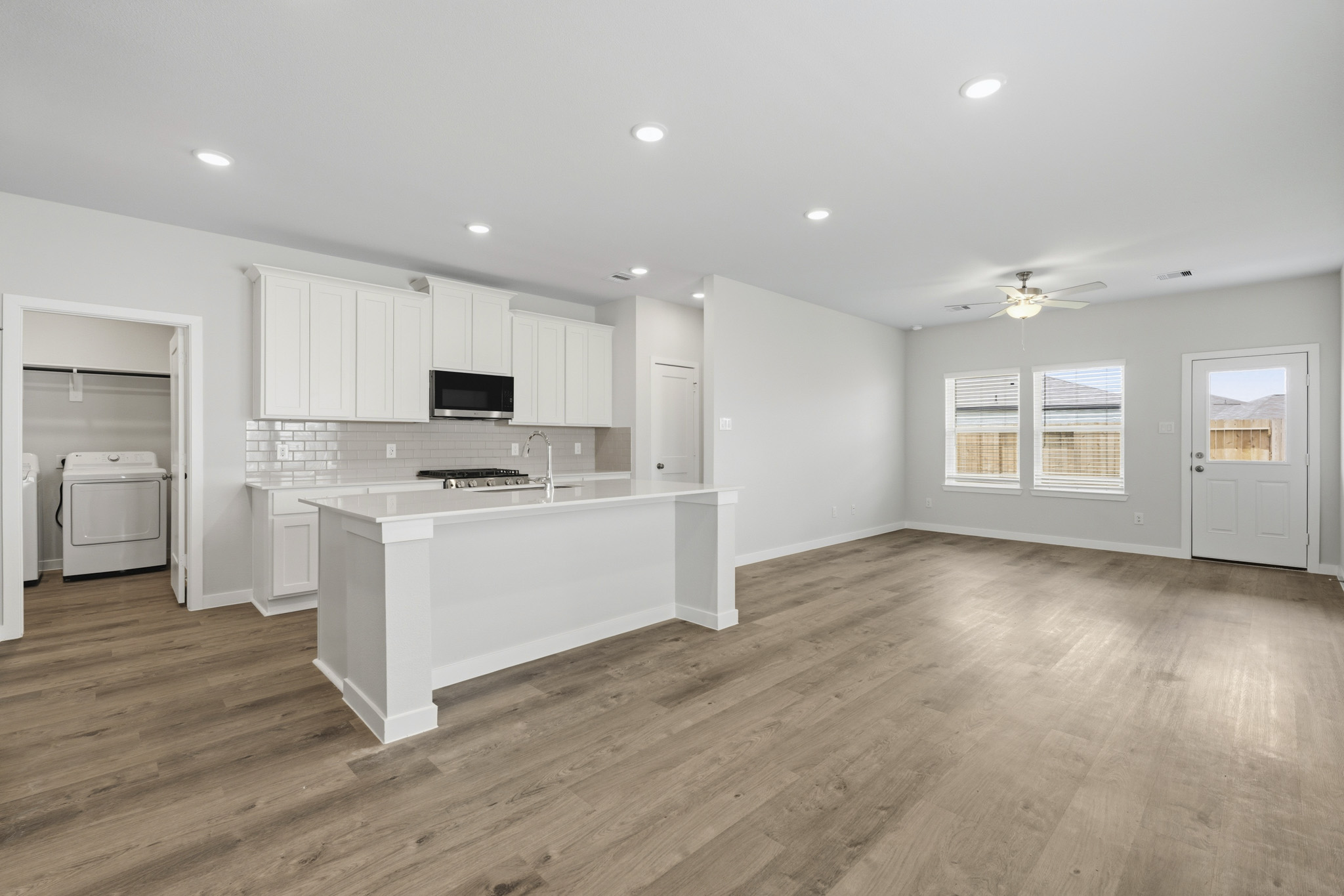 A kitchen with white cabinets.