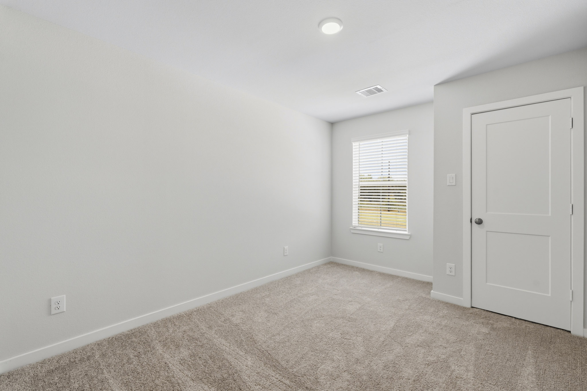 A room with a door and a window.