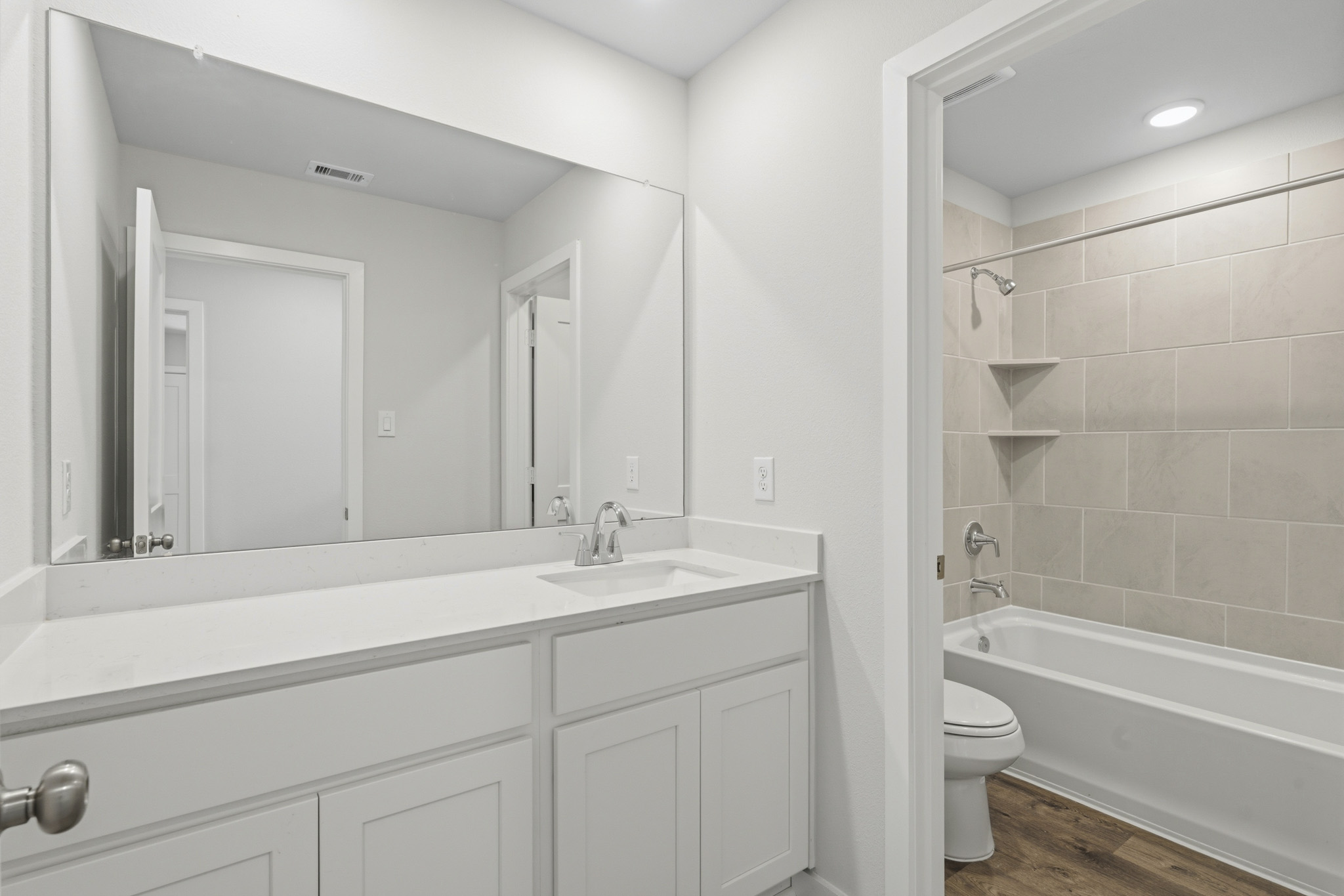 A bathroom with a tub sink and toilet.