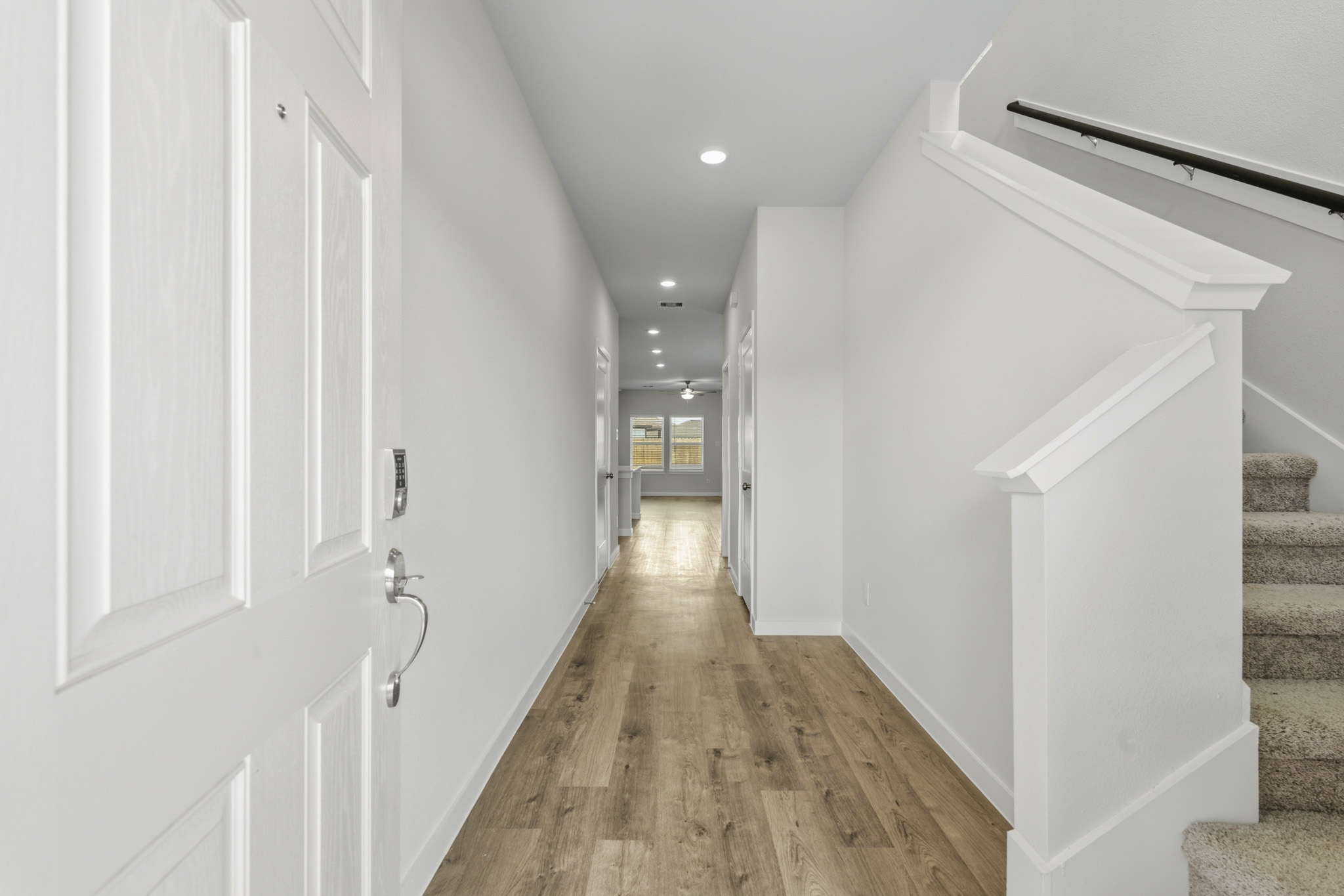A hallway with white walls.