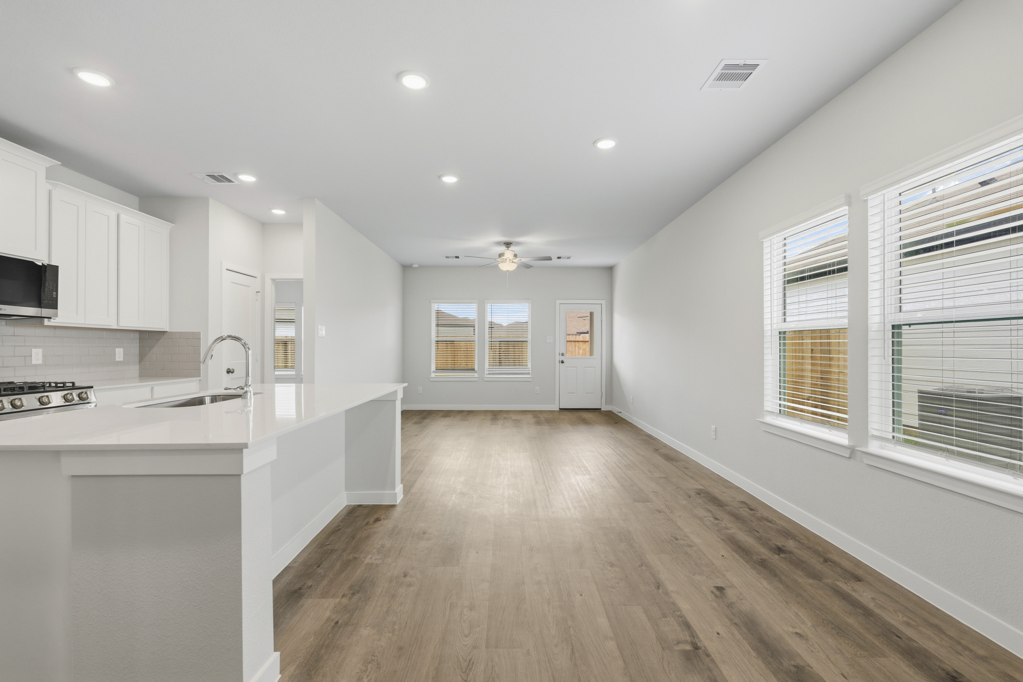 A kitchen with white cabinets.