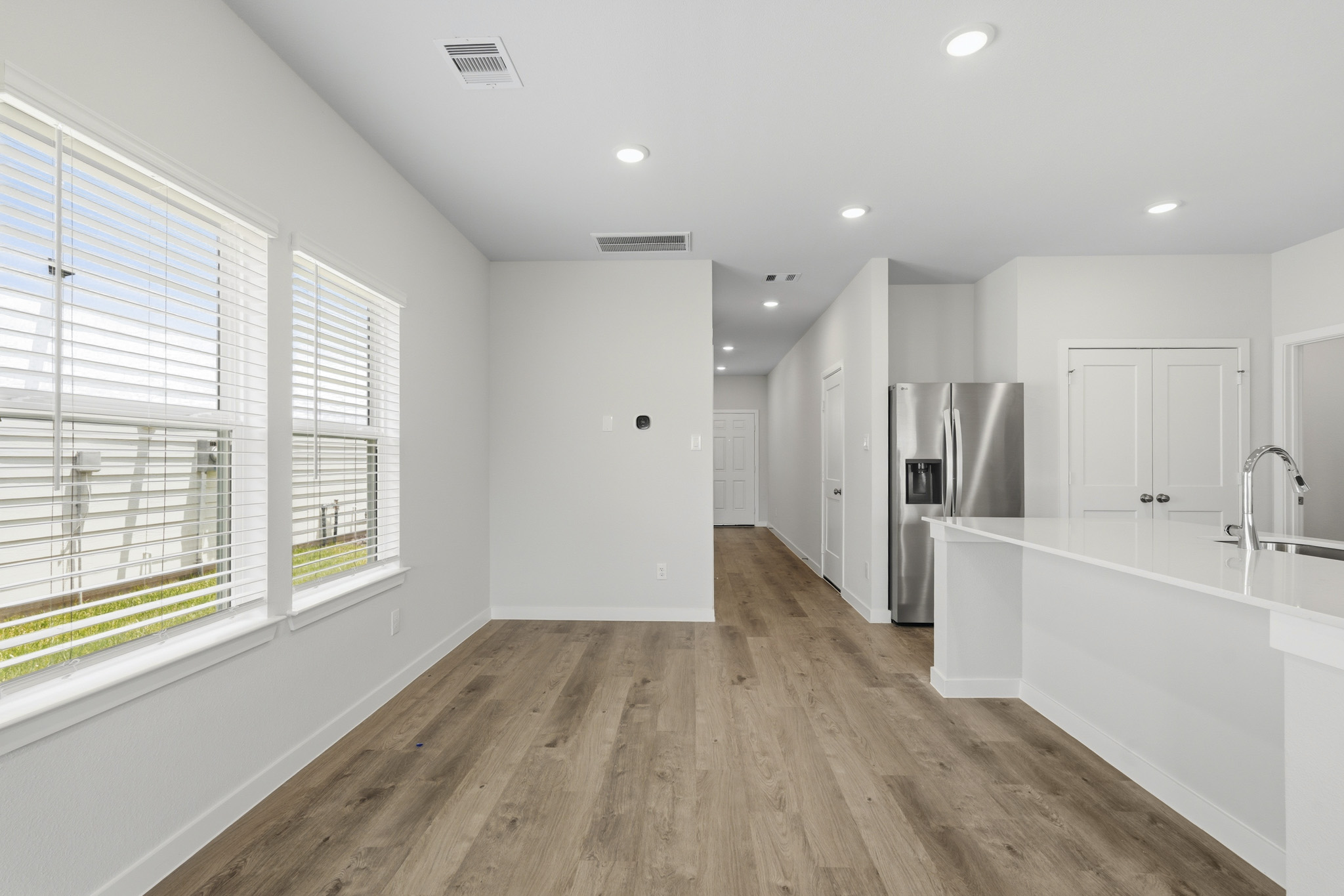 A kitchen with white cabinets.