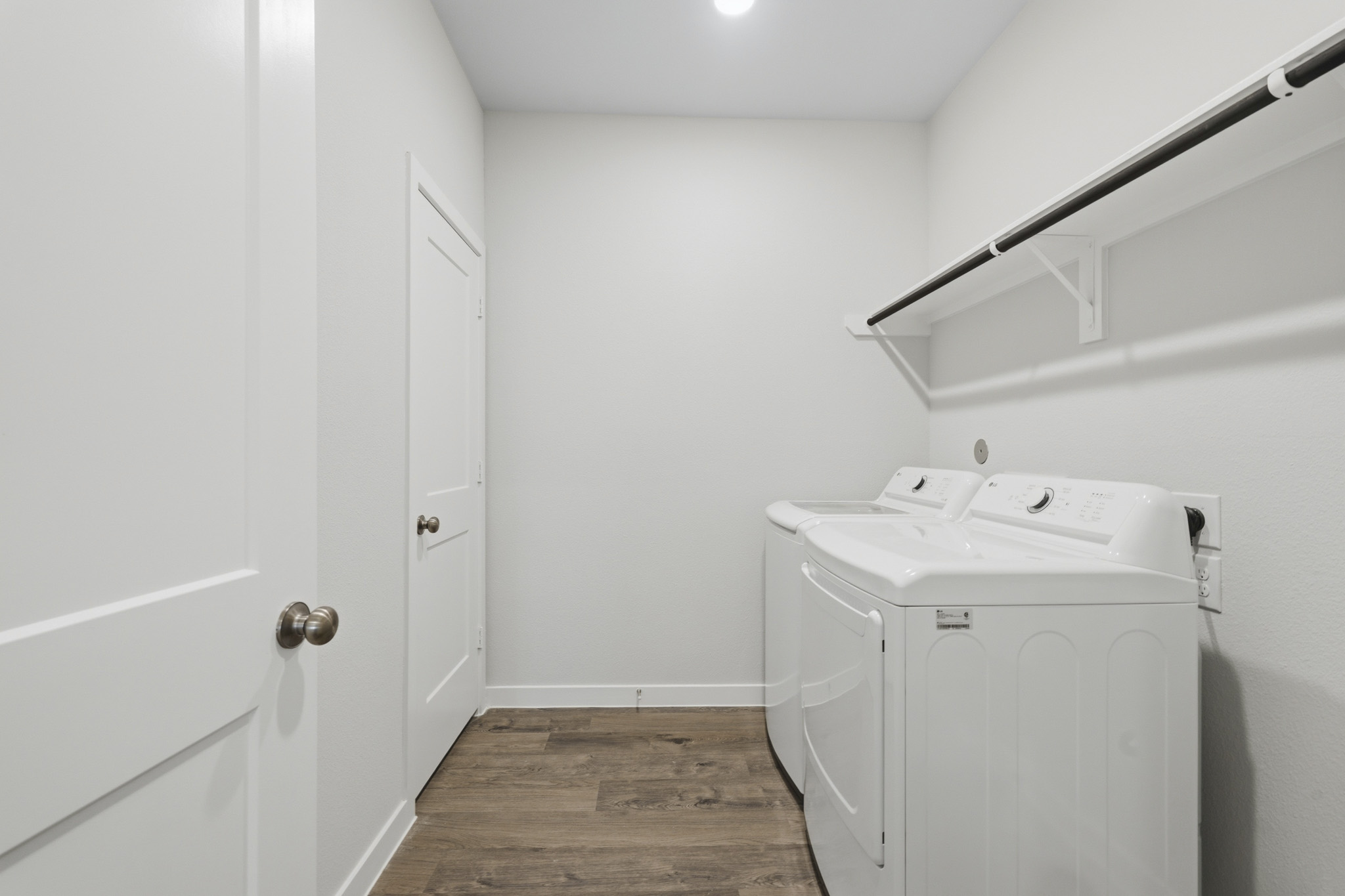 A white laundry machine in a room.