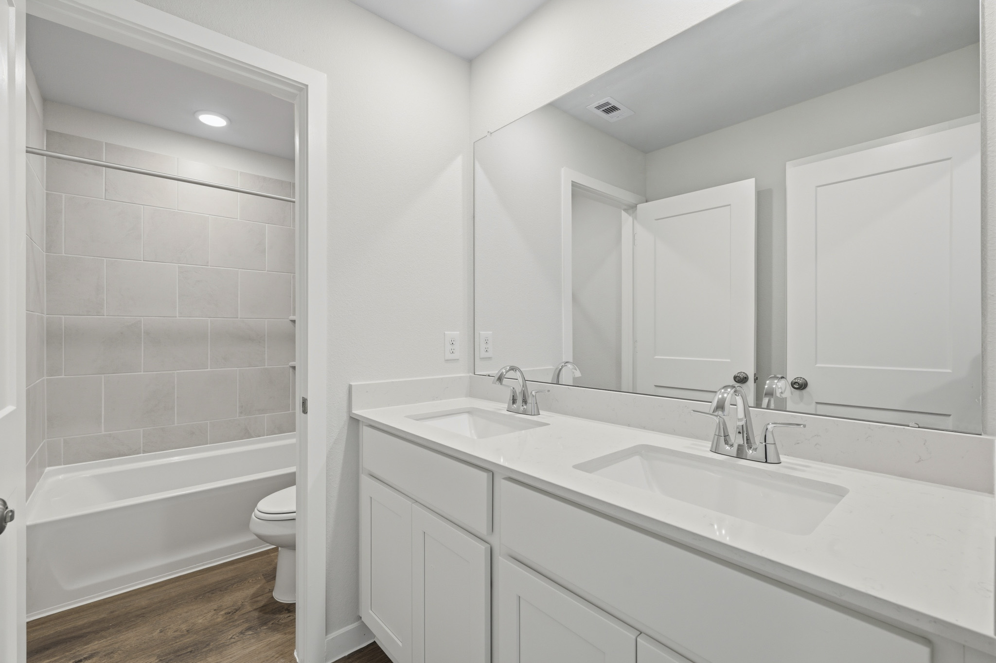 A bathroom with a tub sink and toilet.