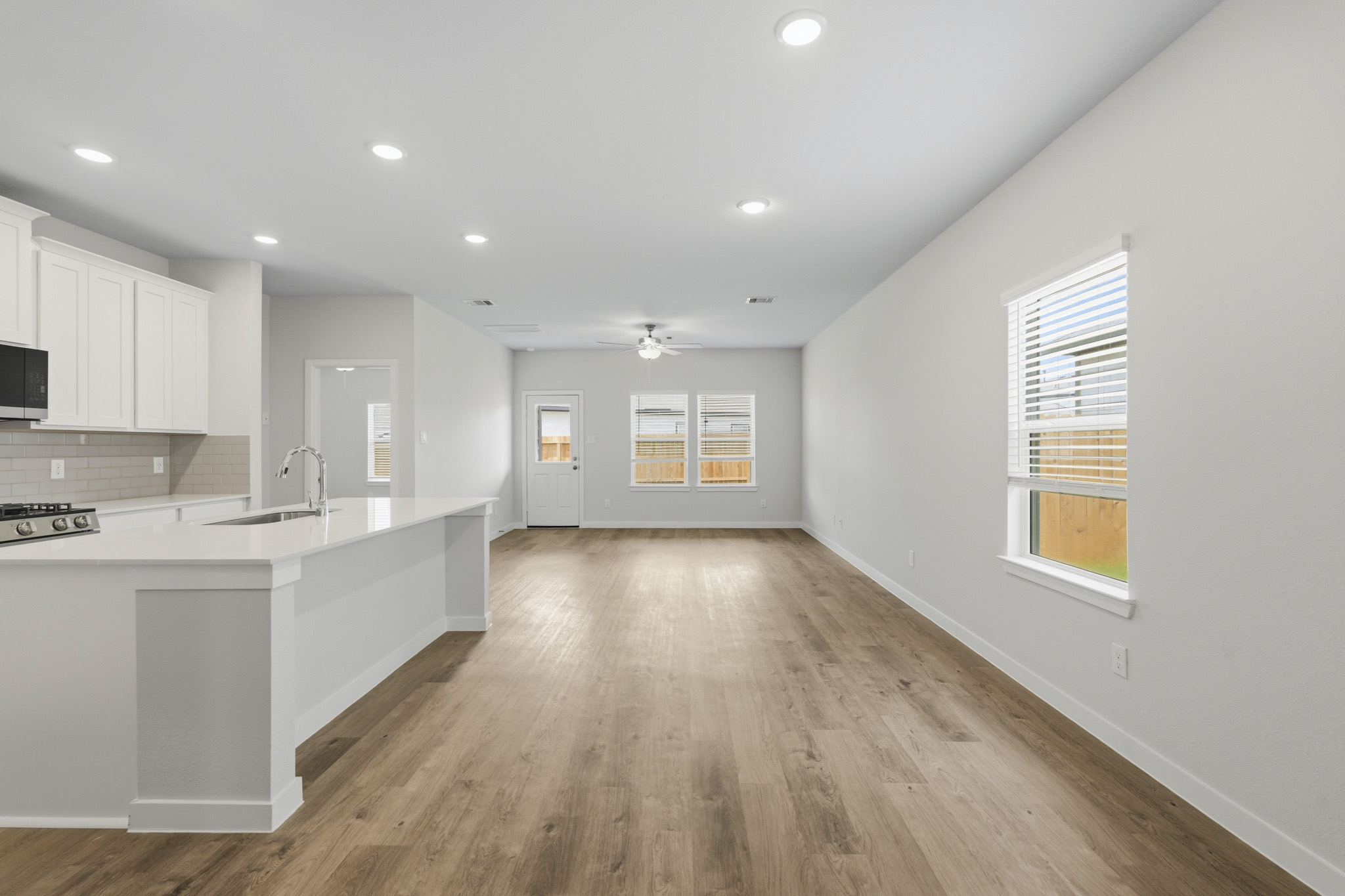 A kitchen with white cabinets.