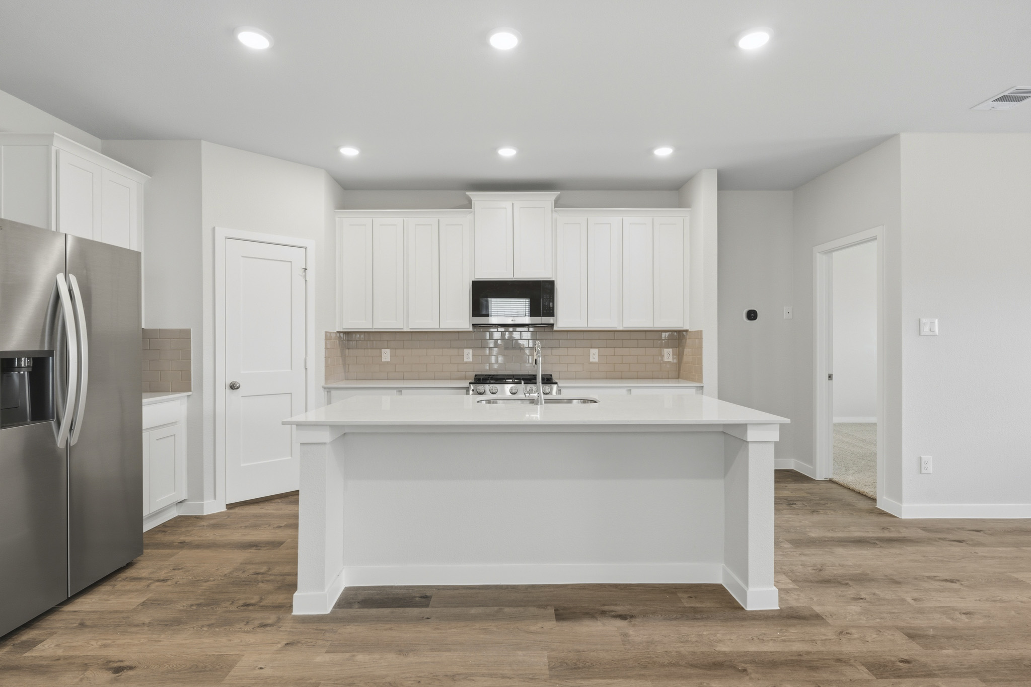 A kitchen with white cabinets.