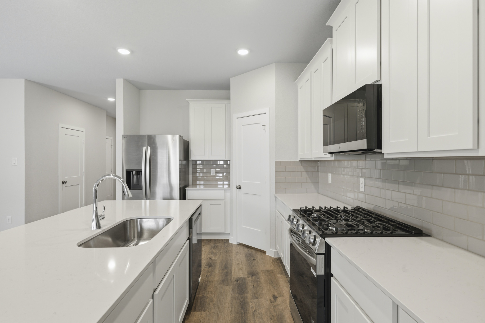 A kitchen with white cabinets.