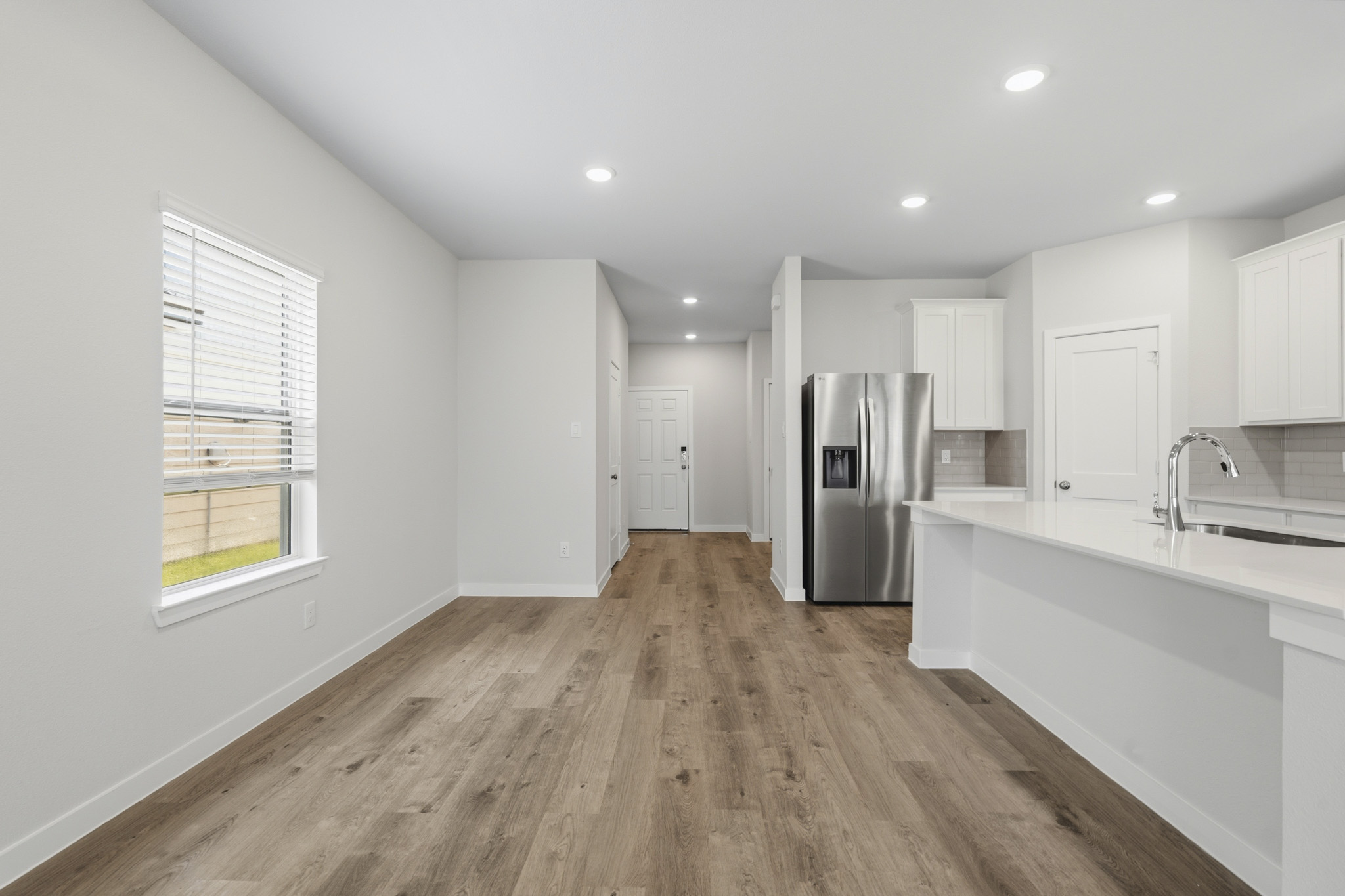 A kitchen with white cabinets.