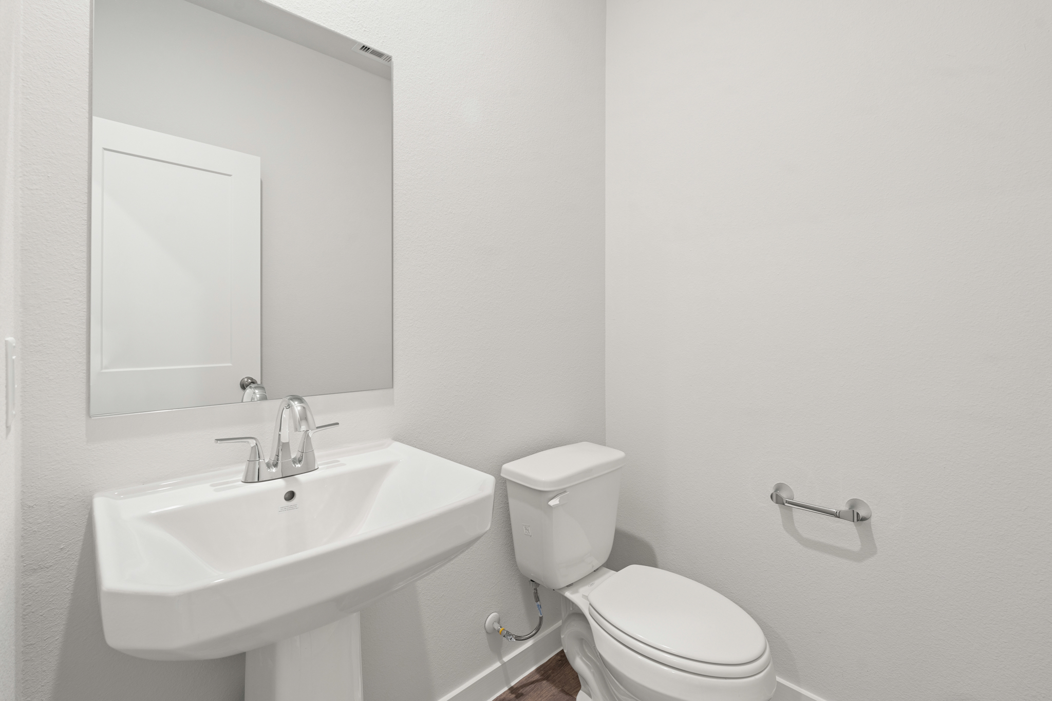 A bathroom with a toilet and sink.