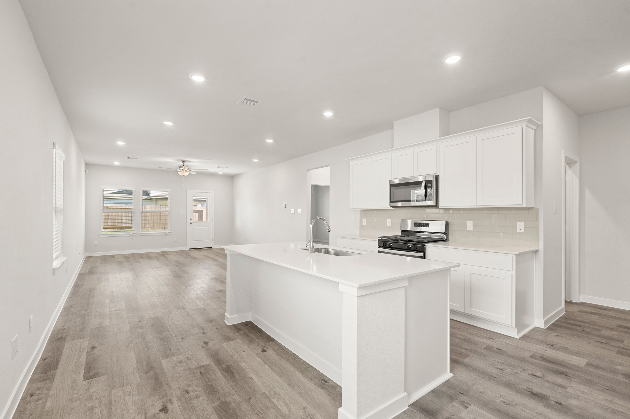 A kitchen with white cabinets.