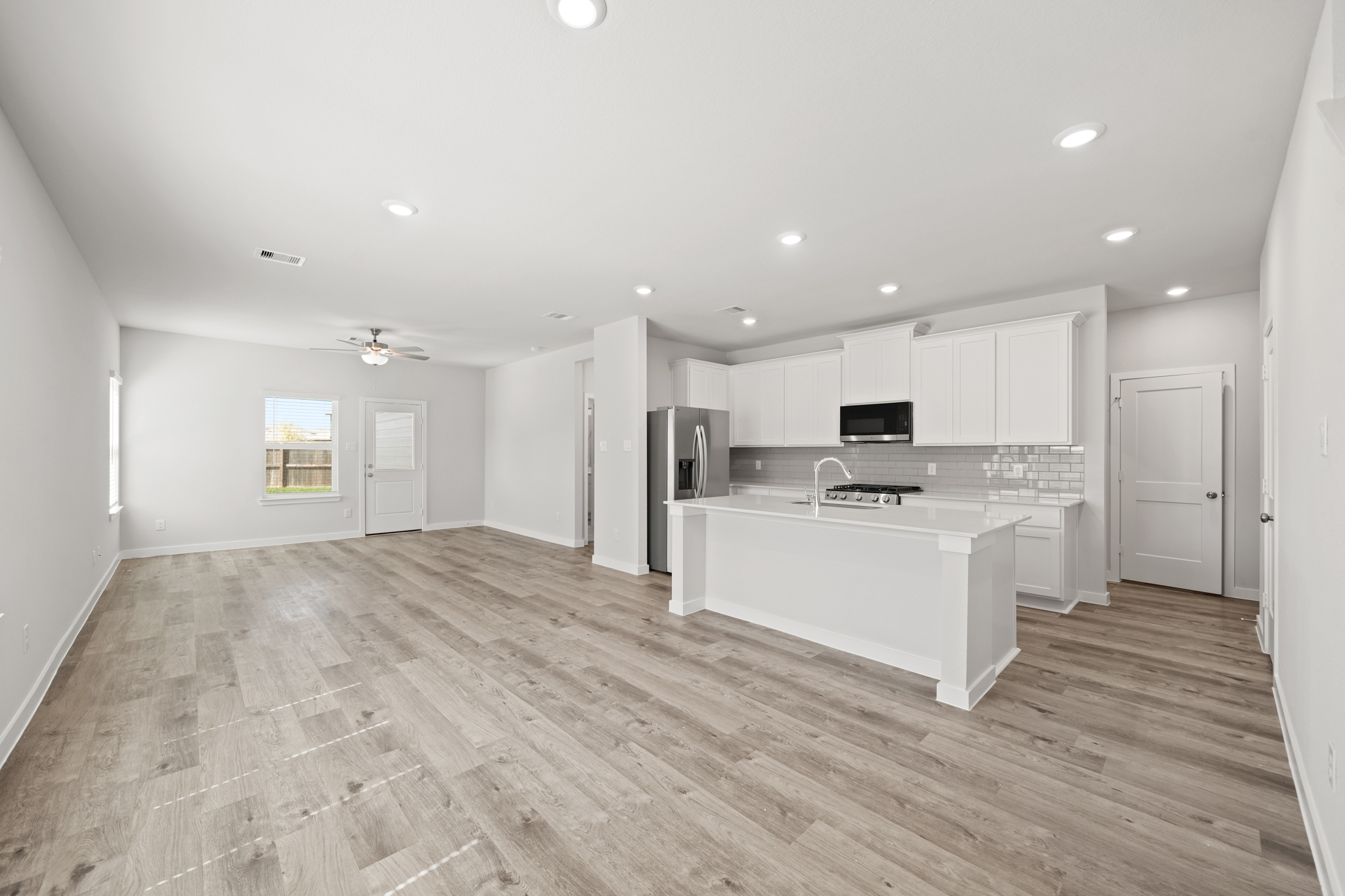 A kitchen with white cabinets.