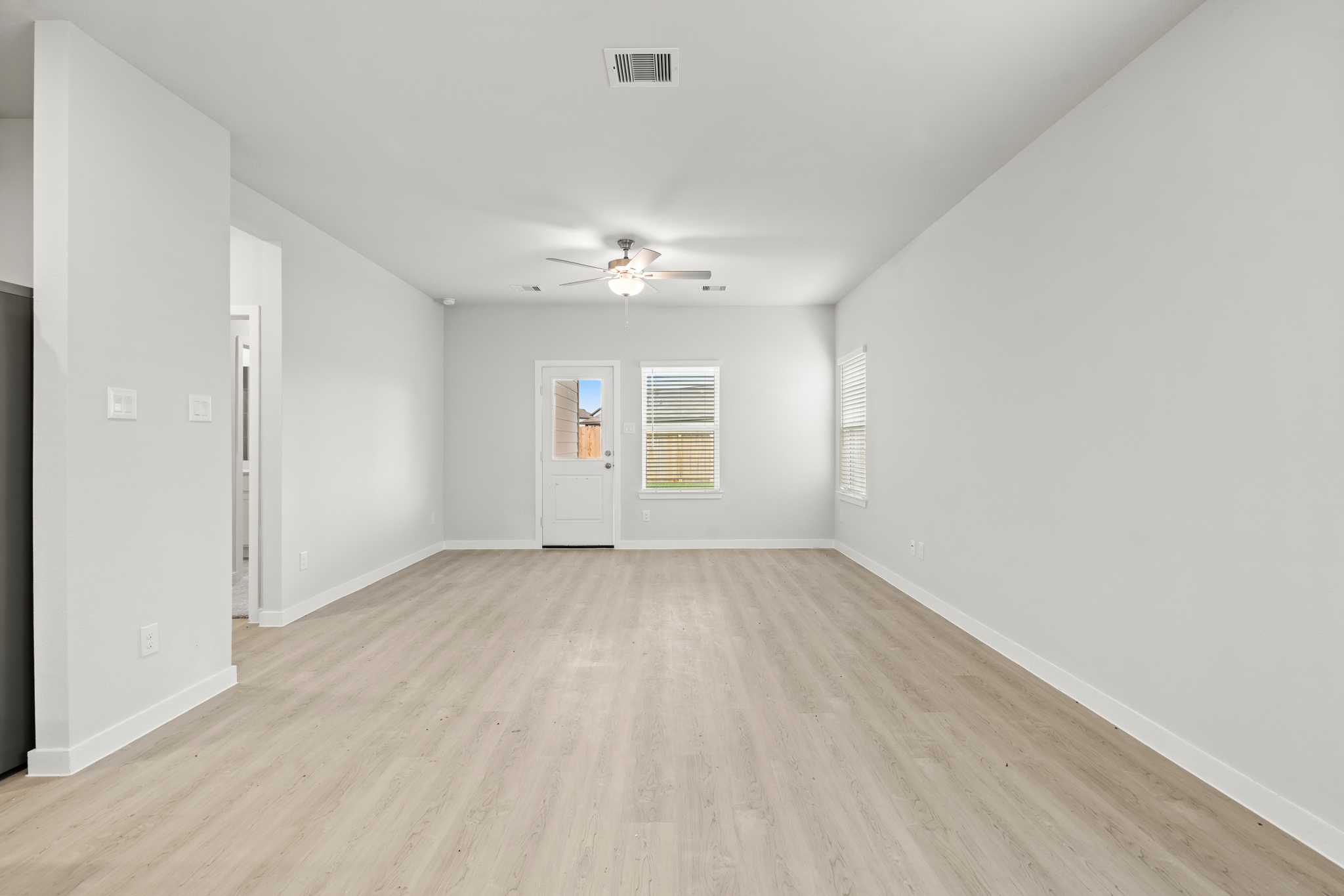 A room with a wood floor and white walls.