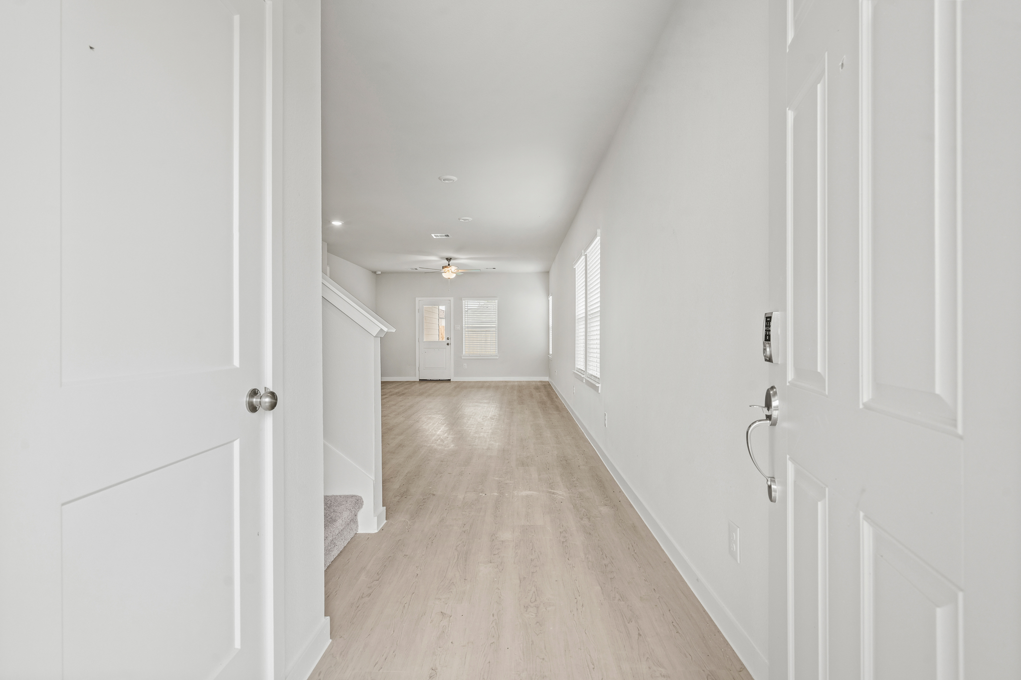 A hallway with white doors.