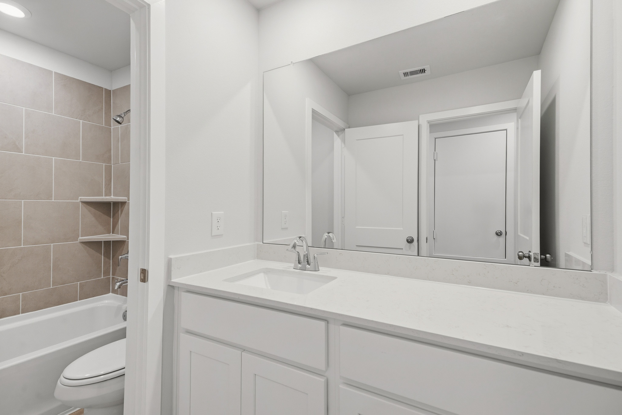 A bathroom with a sink and a toilet.