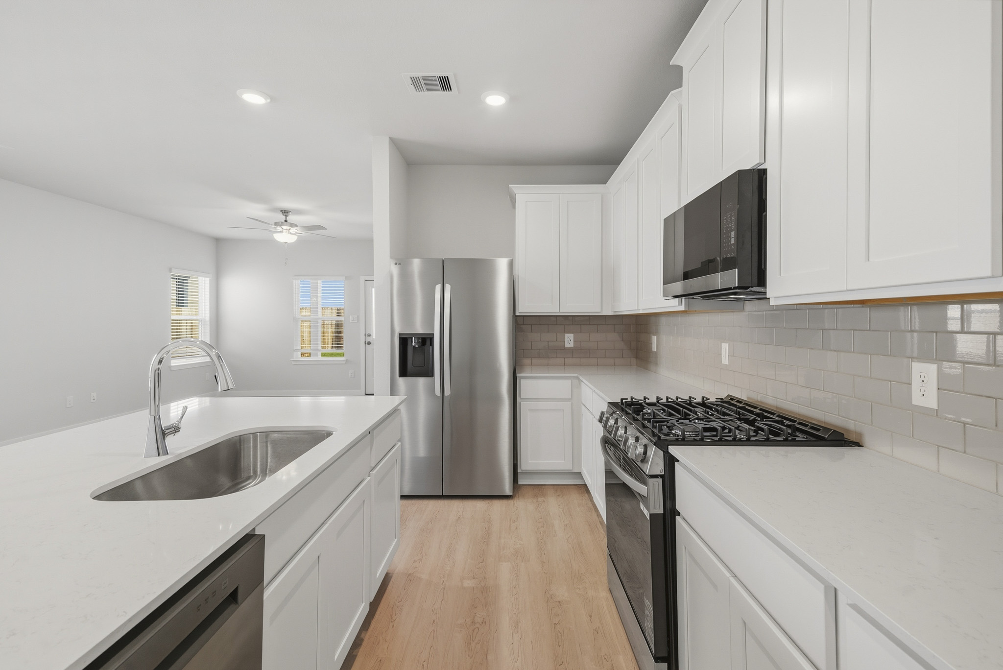 A kitchen with white cabinets.
