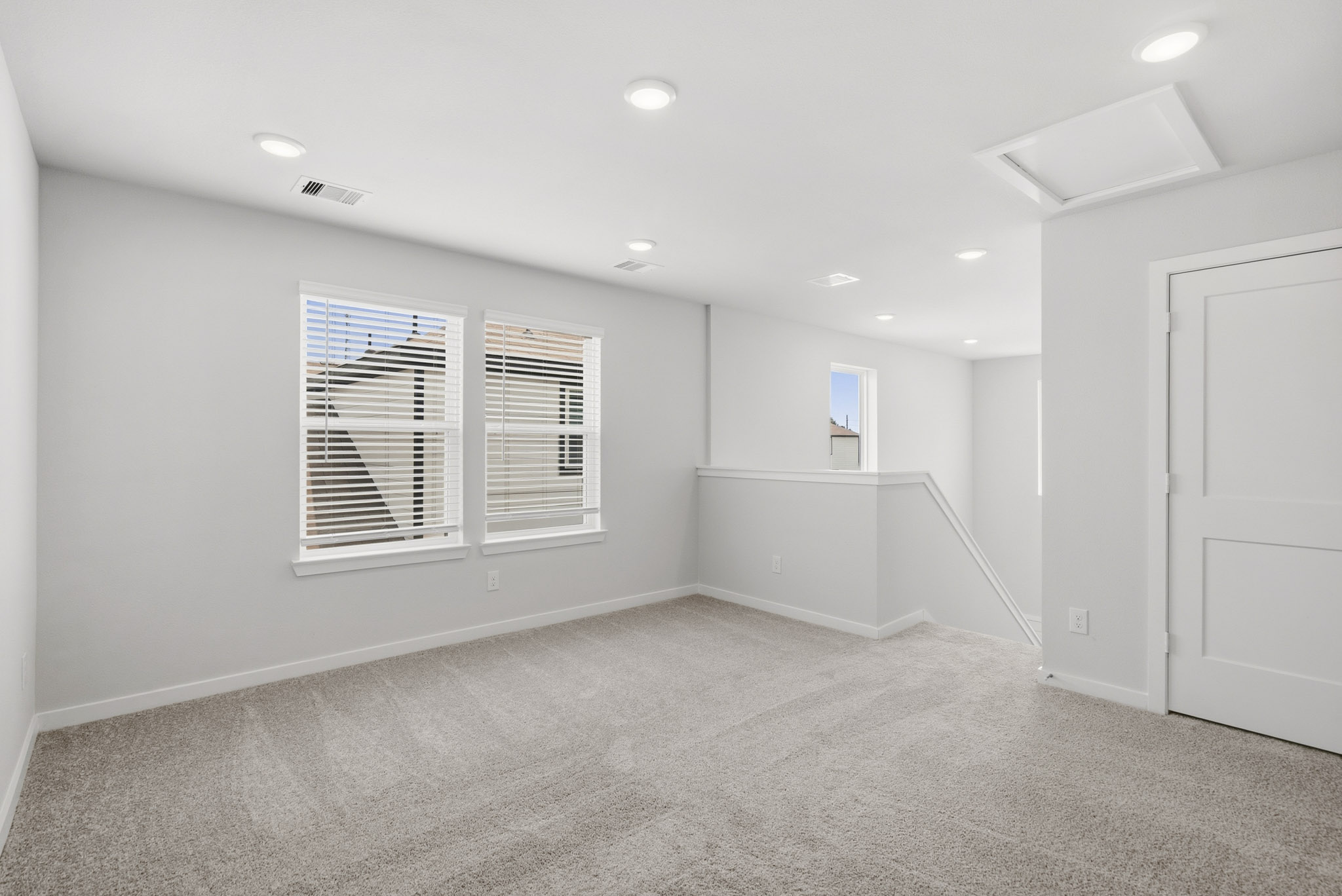 A room with white walls and a window.