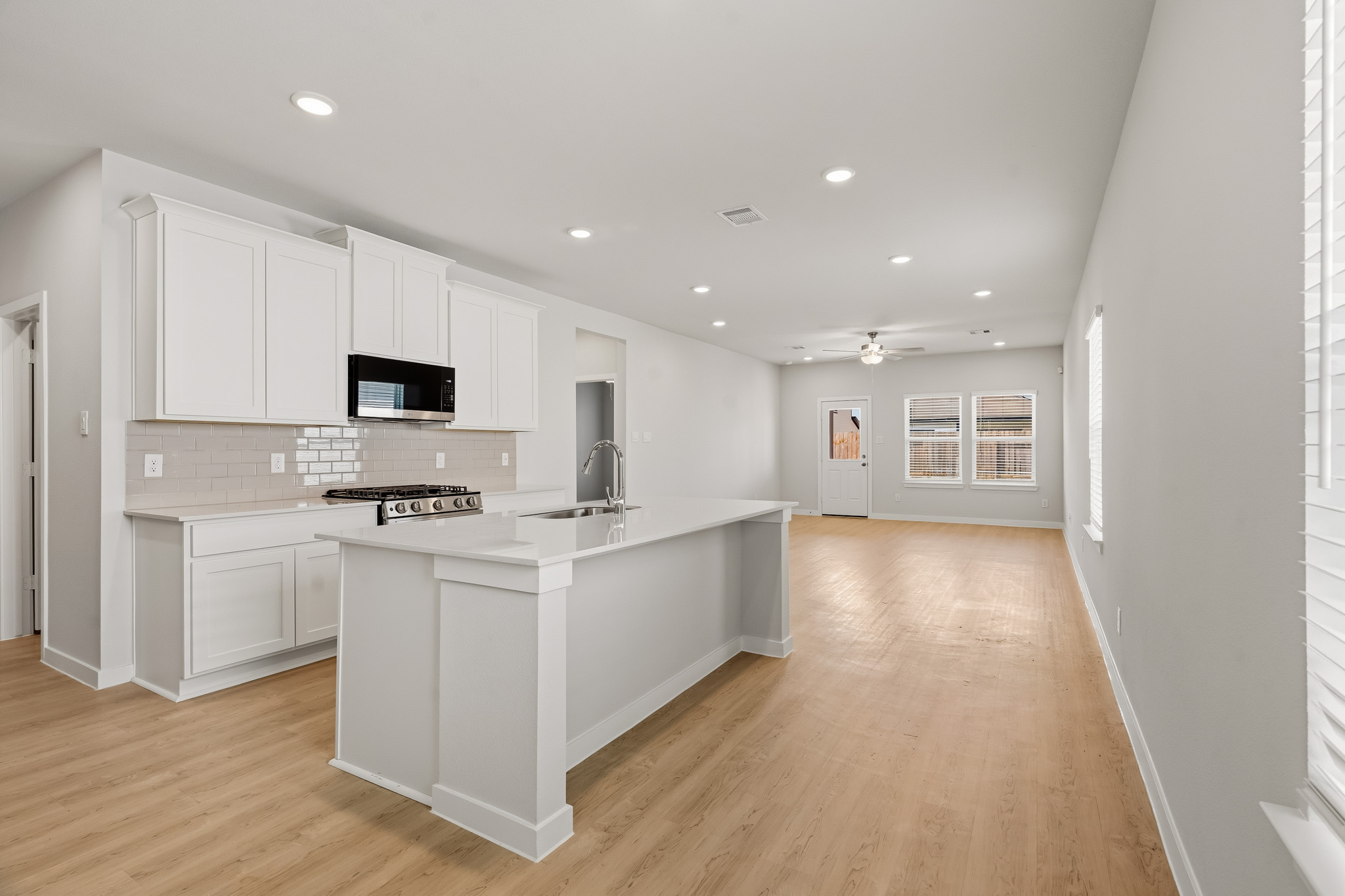 A kitchen with white cabinets.