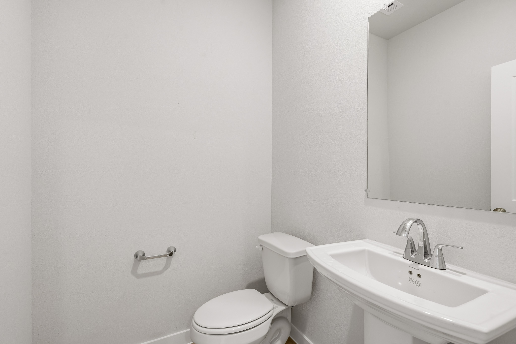 A bathroom with a toilet and sink.