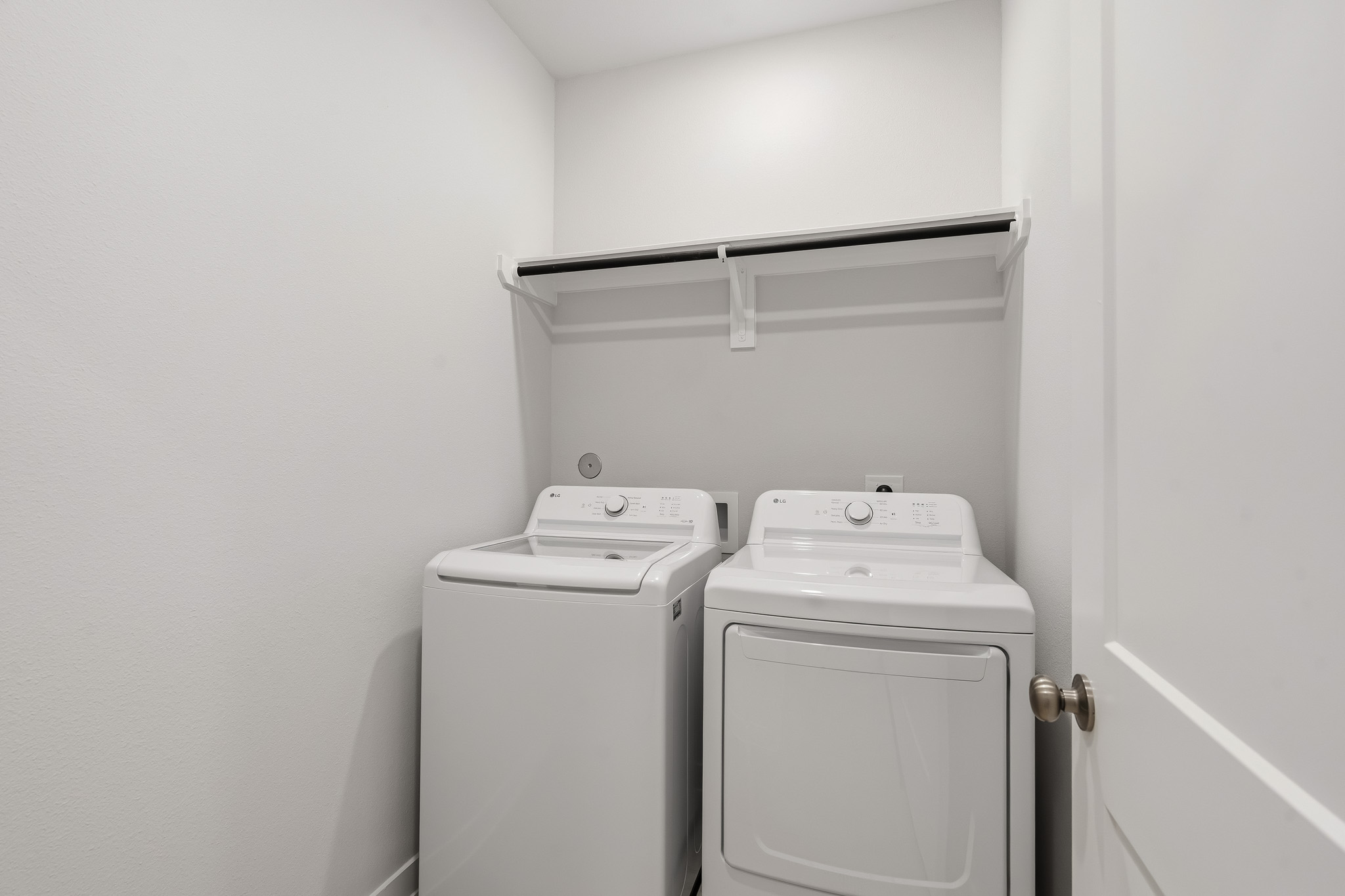A white washing machine and a white door.