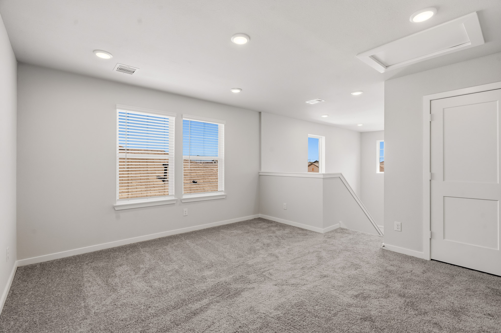 A room with white walls and windows.