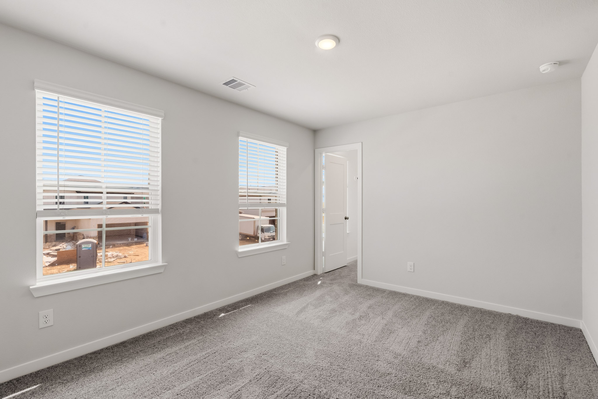 A room with a window and a door.