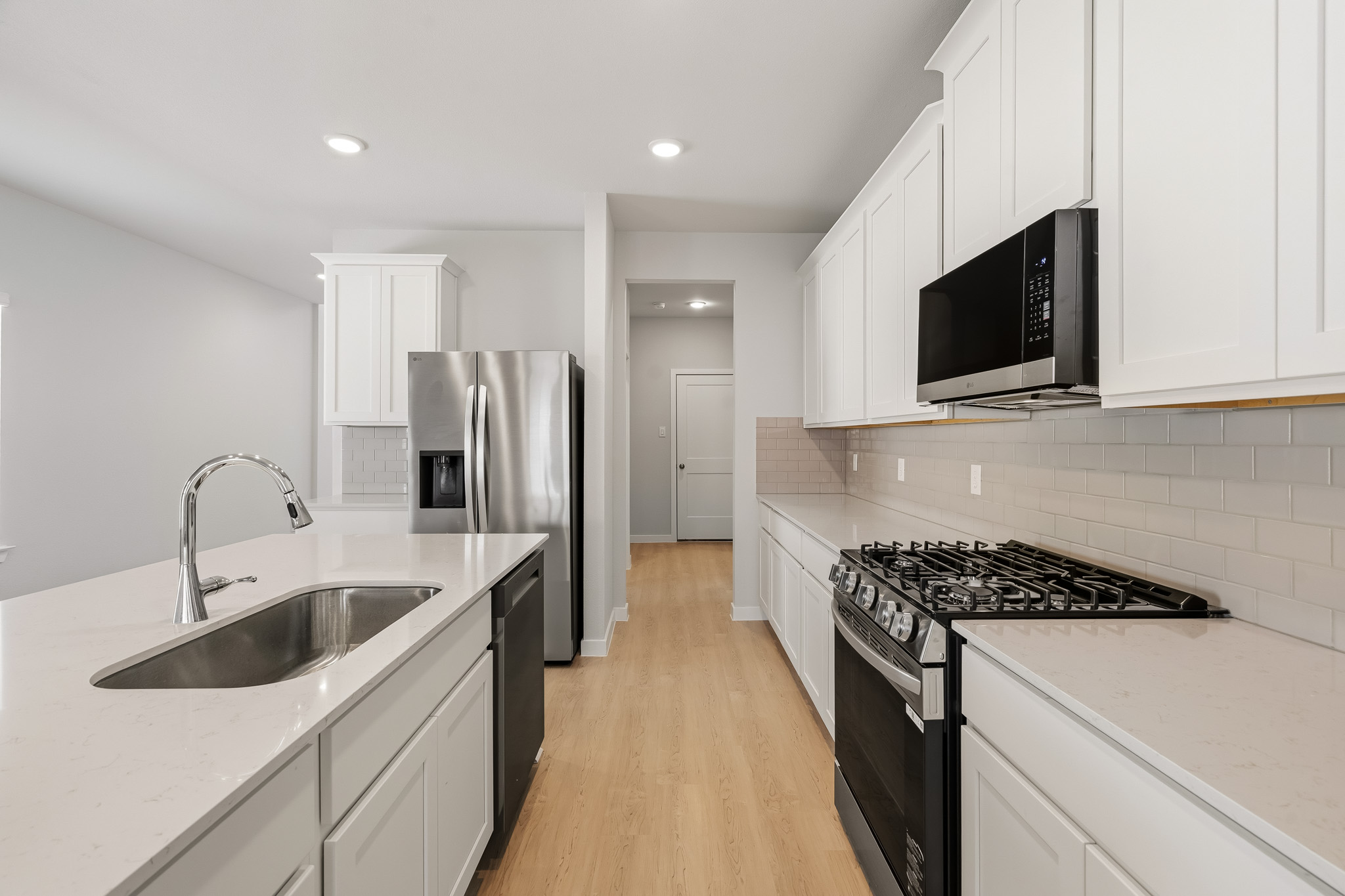 A kitchen with white cabinets.