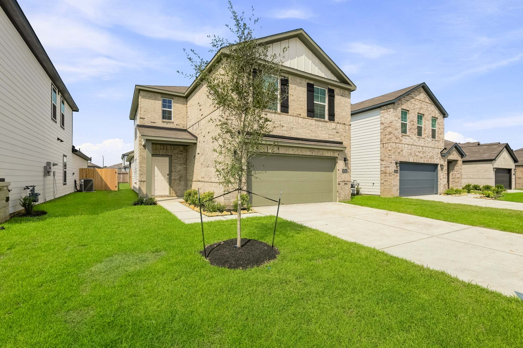 A house with a tree in the front yard.