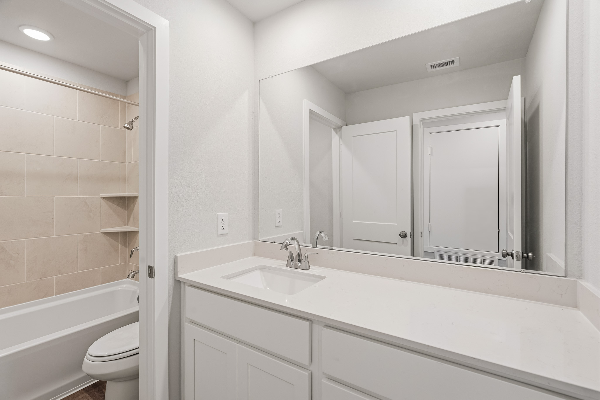 A bathroom with a tub sink and toilet.