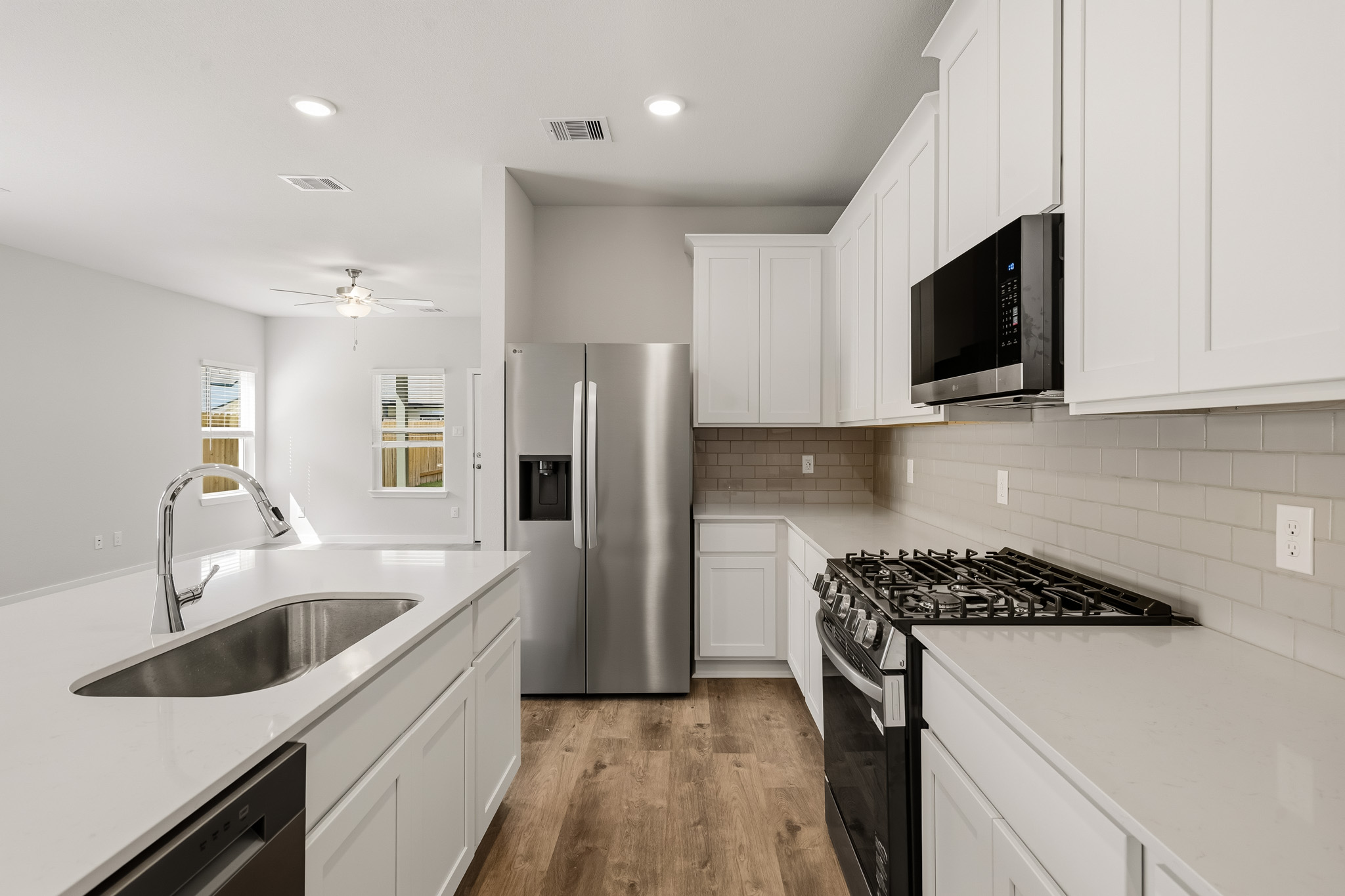 A kitchen with white cabinets.