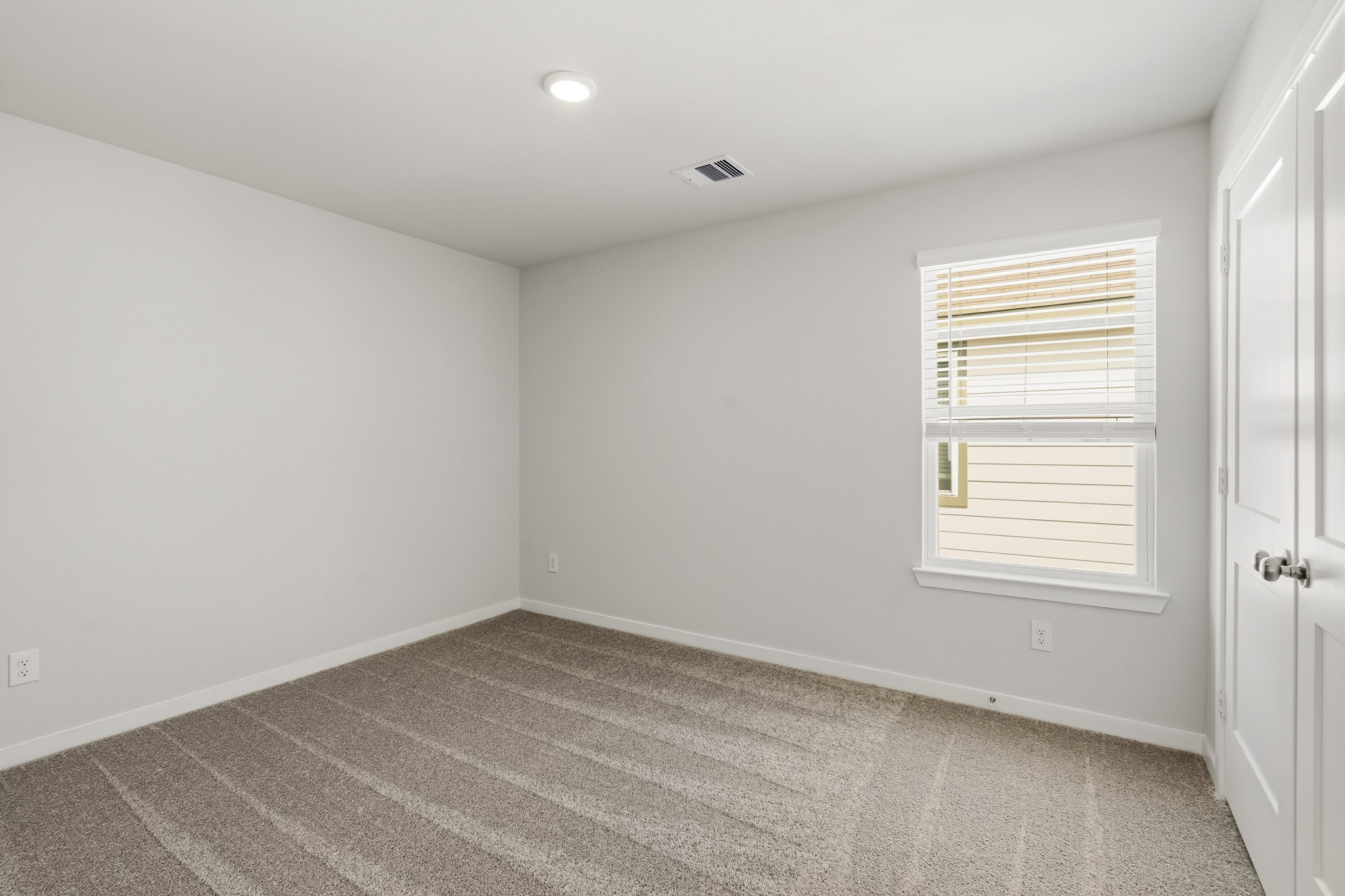 A room with a door and a window.