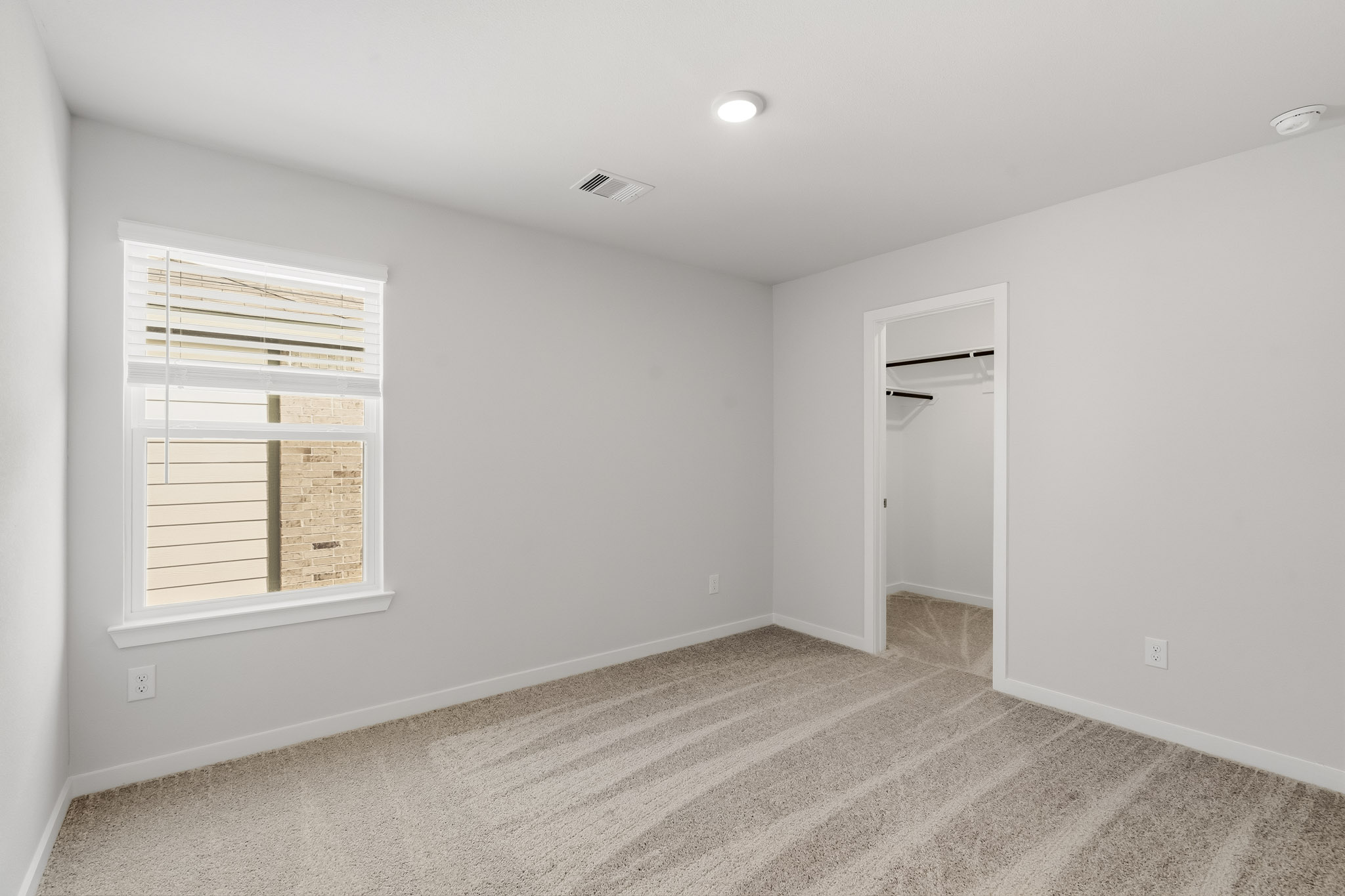 A hallway with a white wall.